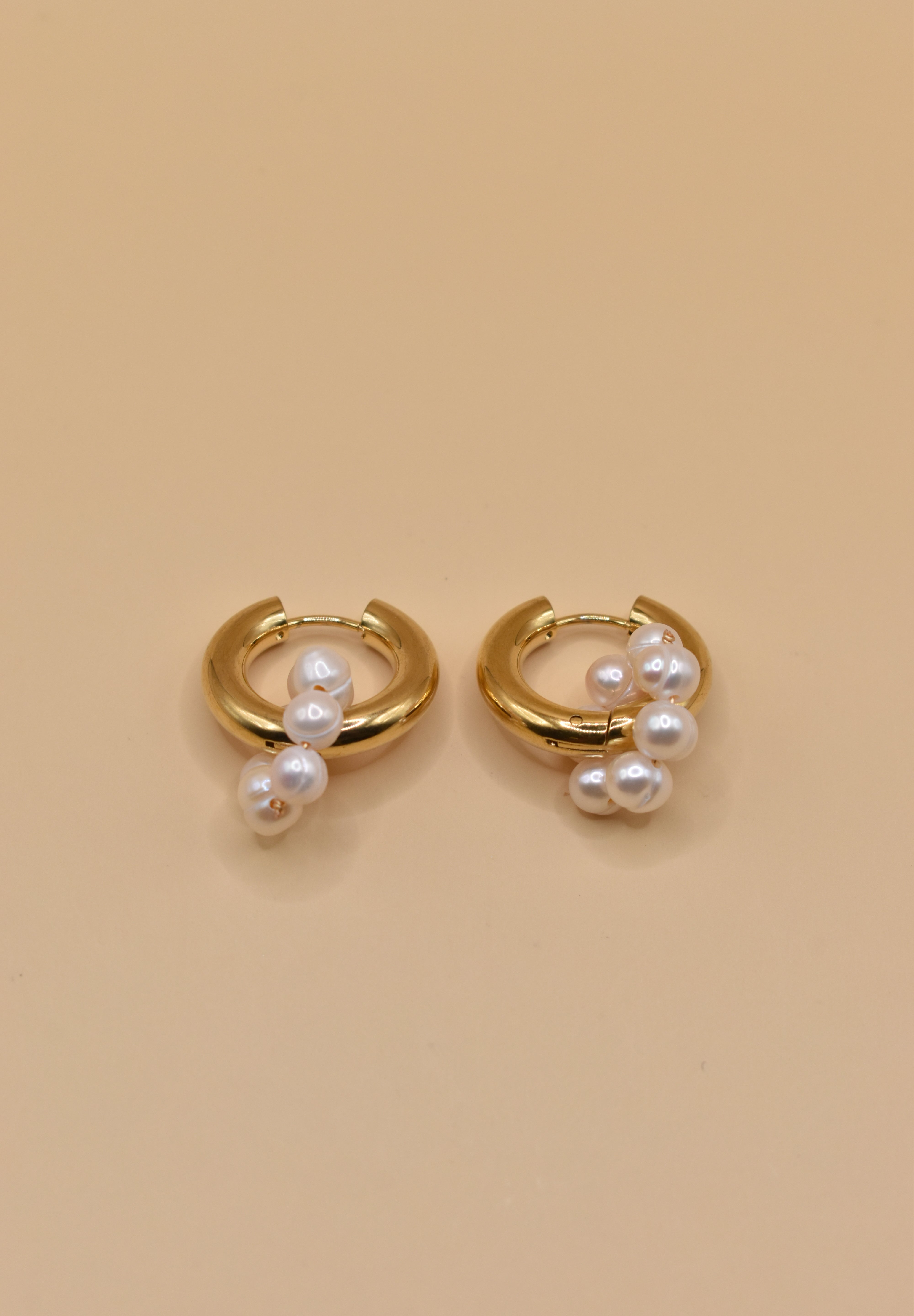 Pearl statement huggies earrings with secure closure