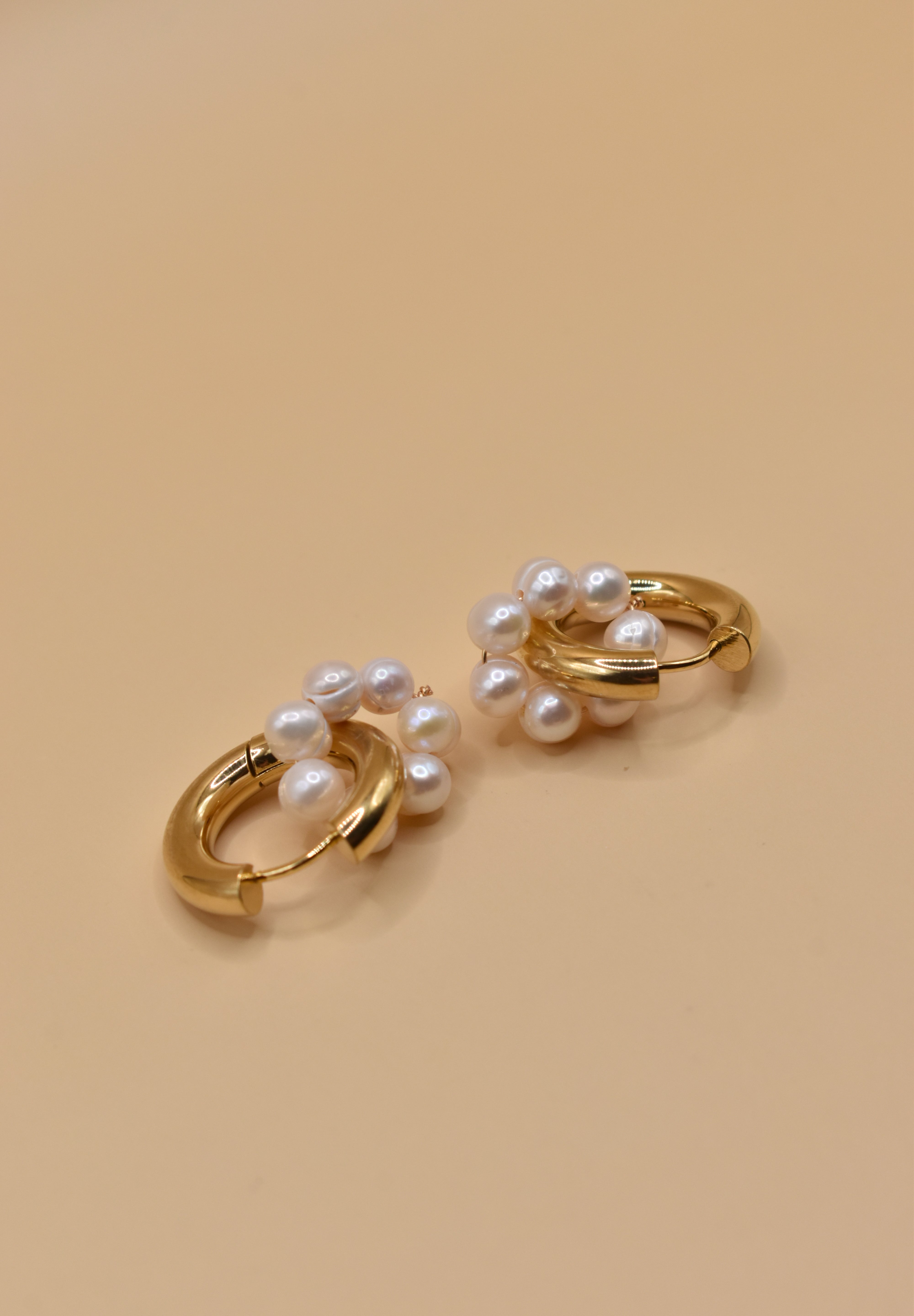 Pearl statement huggies earrings with secure closure