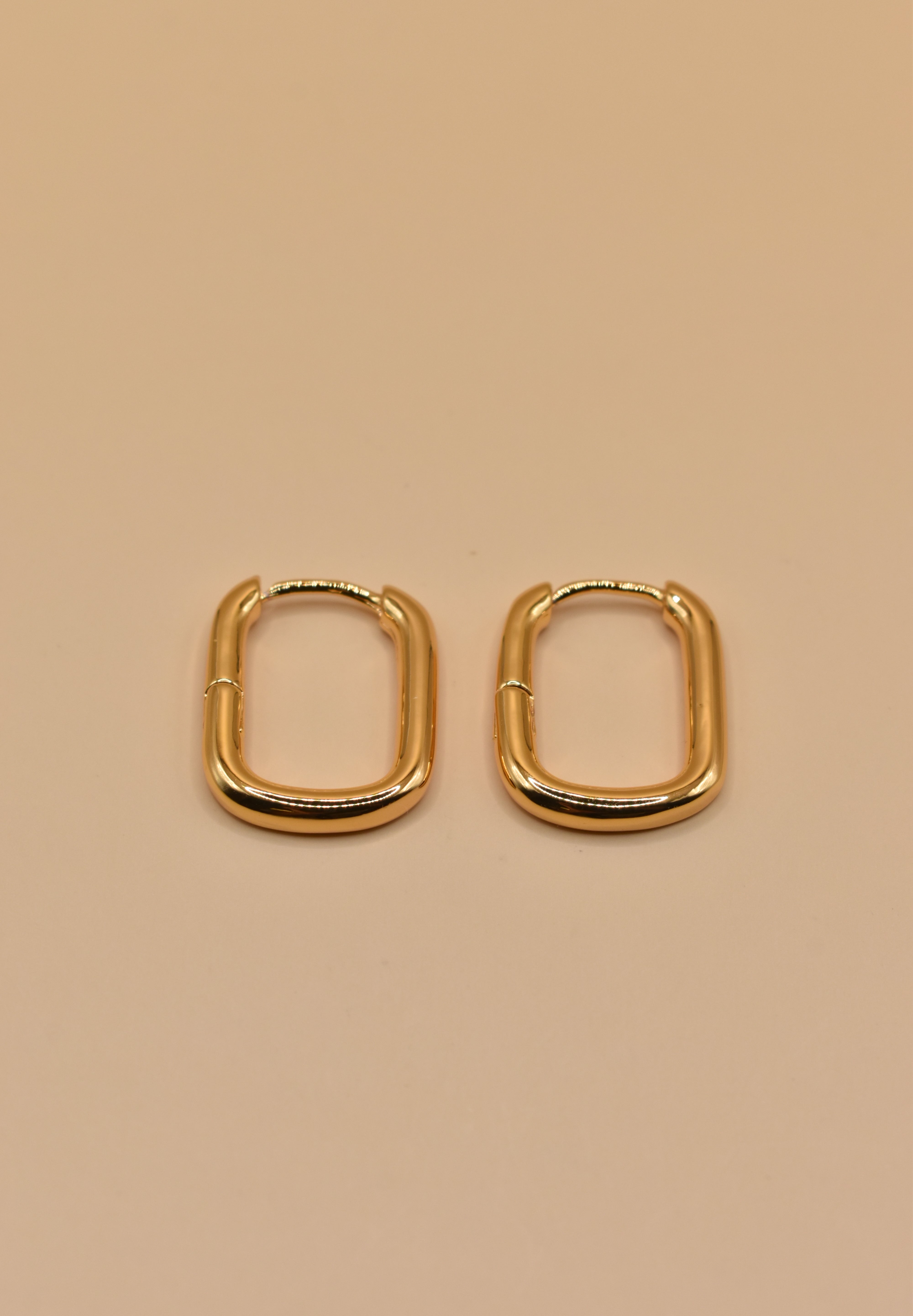 Gold U Huggies Earrings with curved hoop charm design