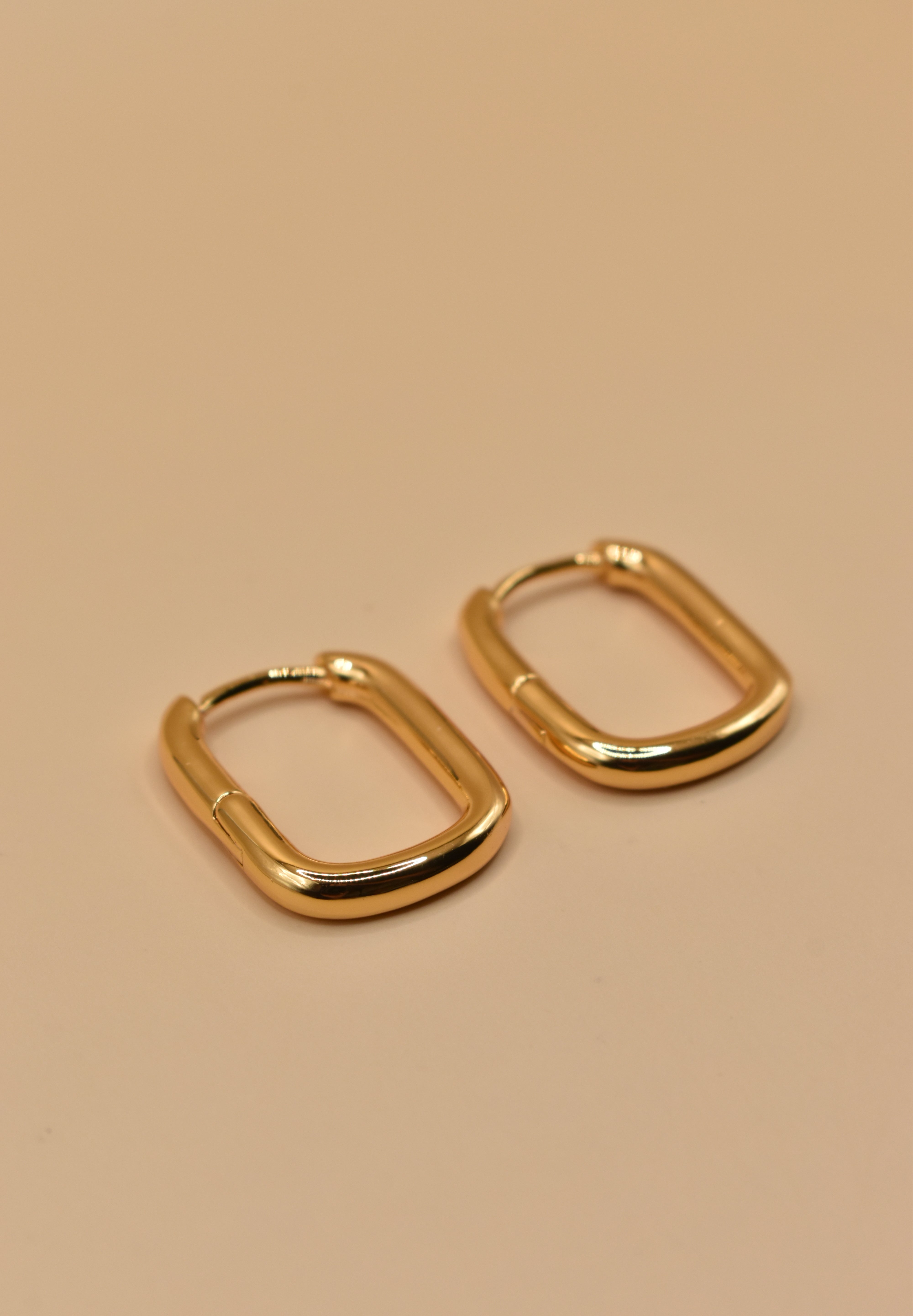 Gold U Huggies Earrings with curved hoop charm design