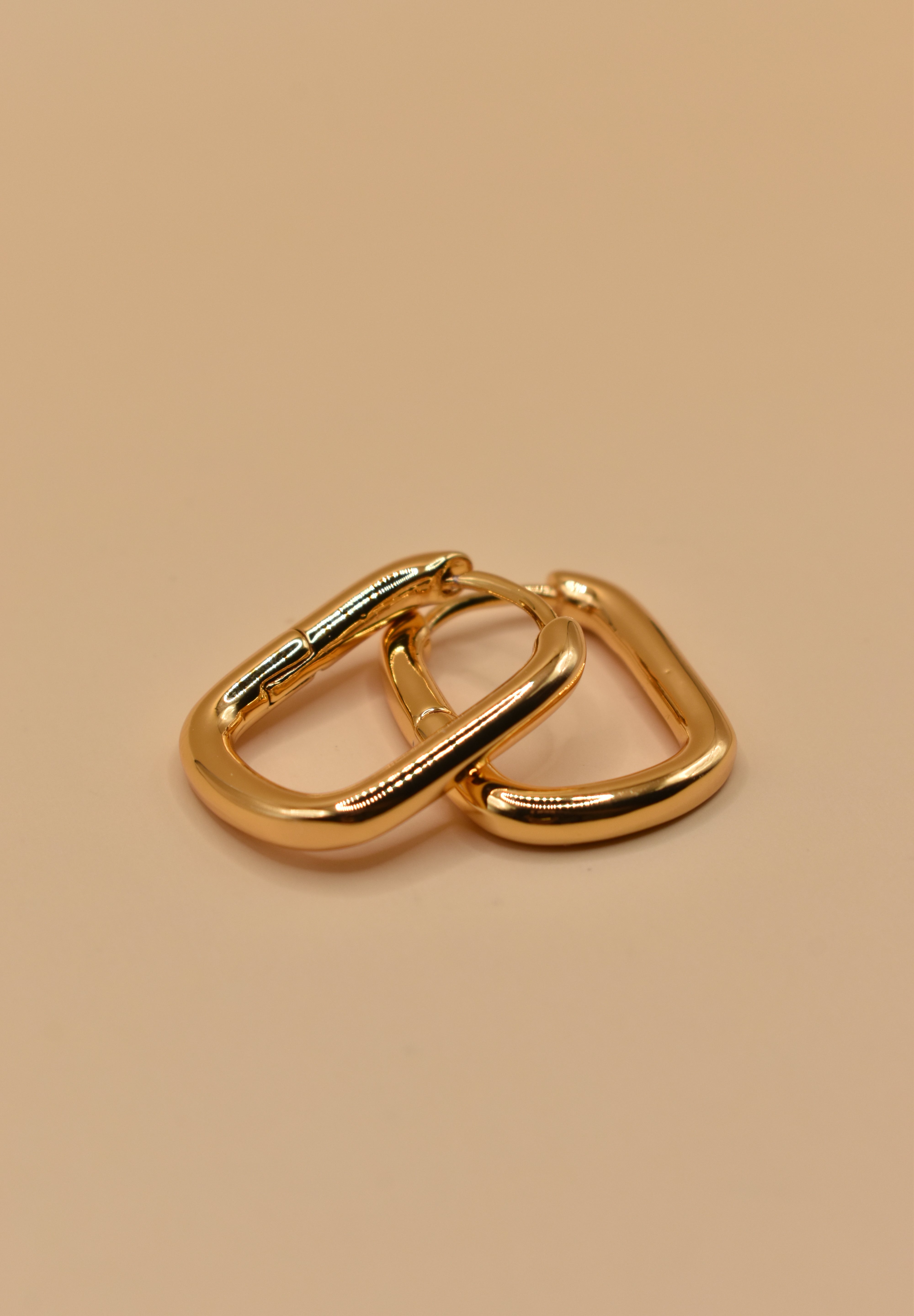Gold U Huggies Earrings with curved hoop charm design