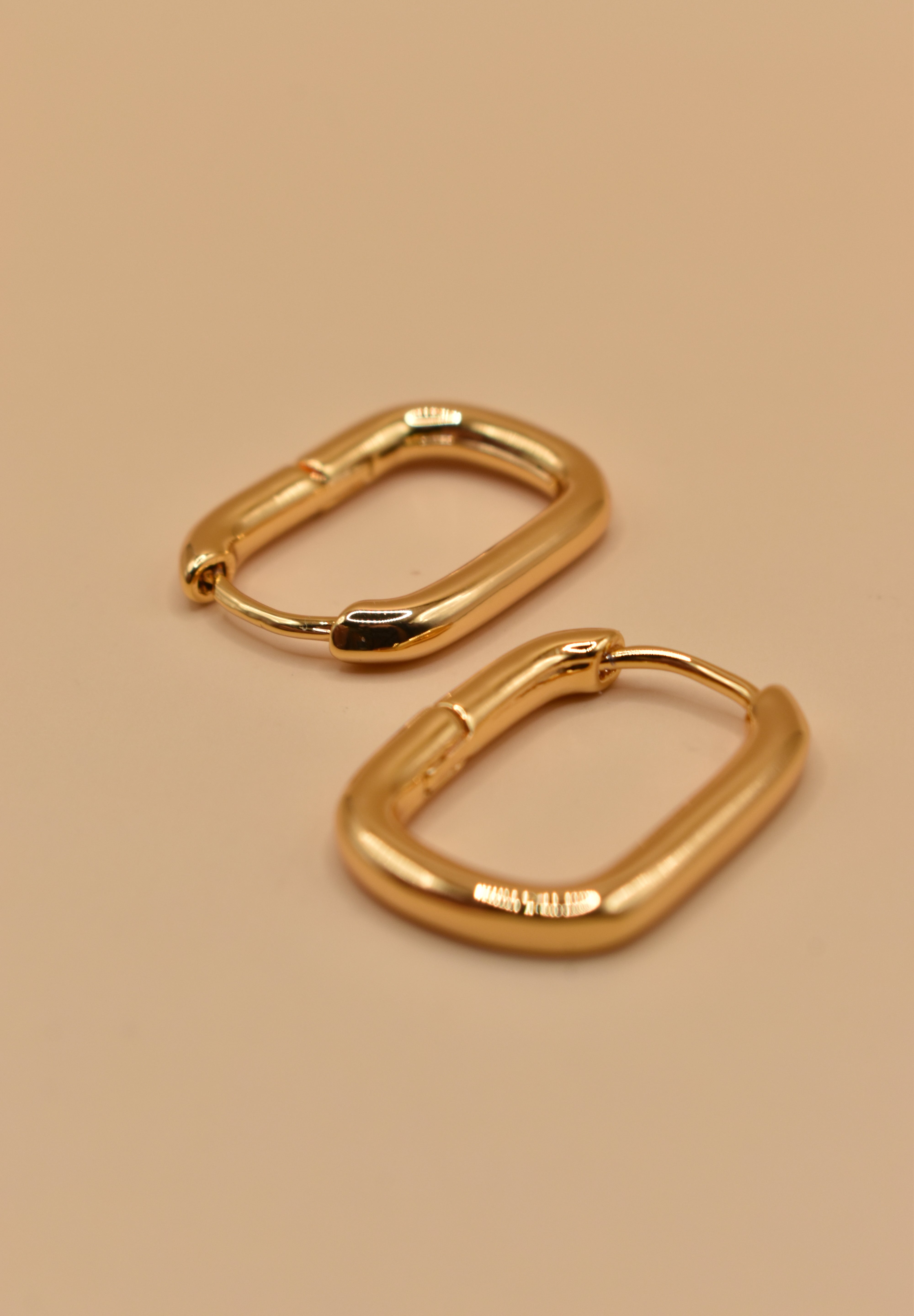 Gold U Huggies Earrings with curved hoop charm design