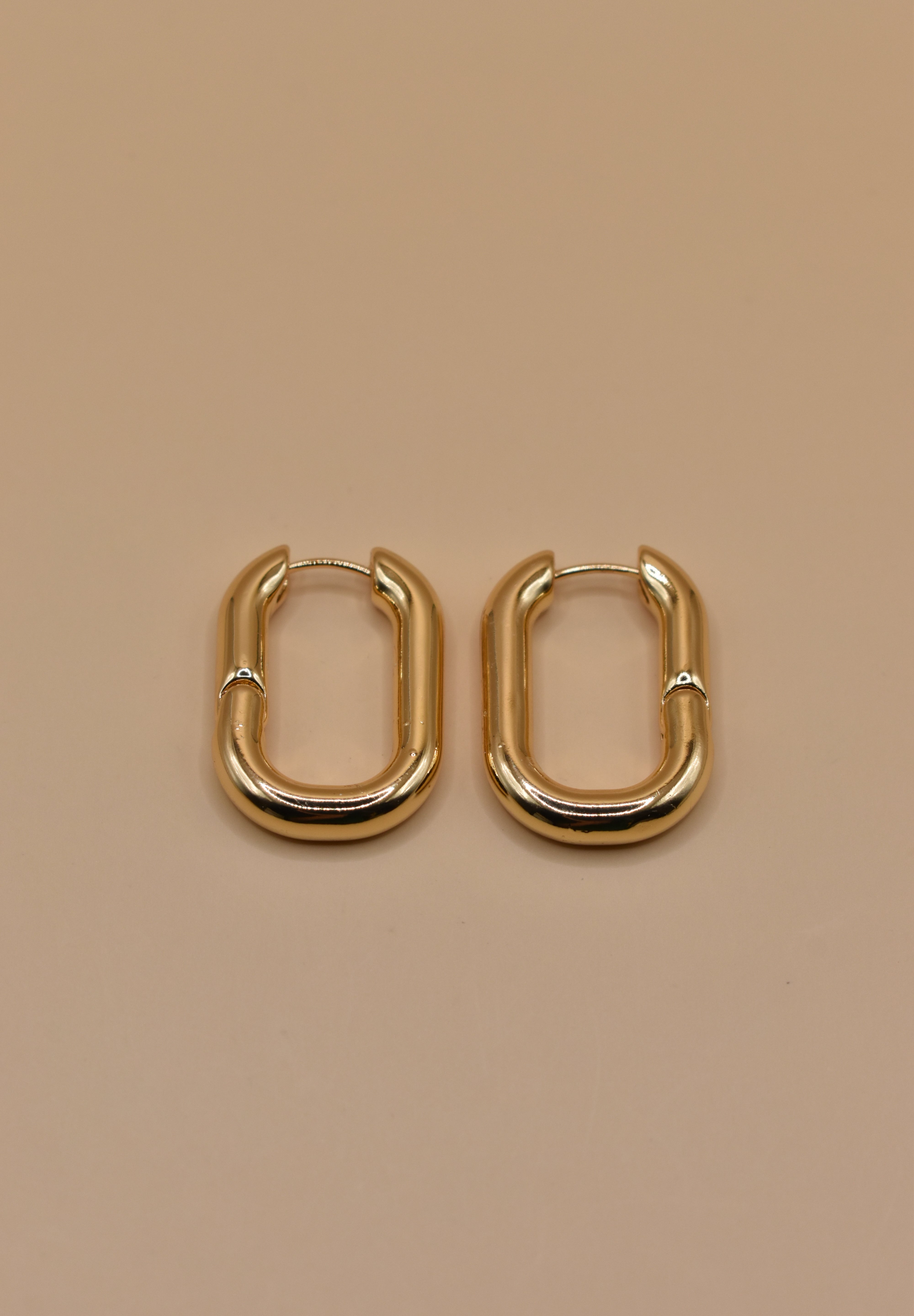 Gold U Huggies Earrings with curved hoop charm design