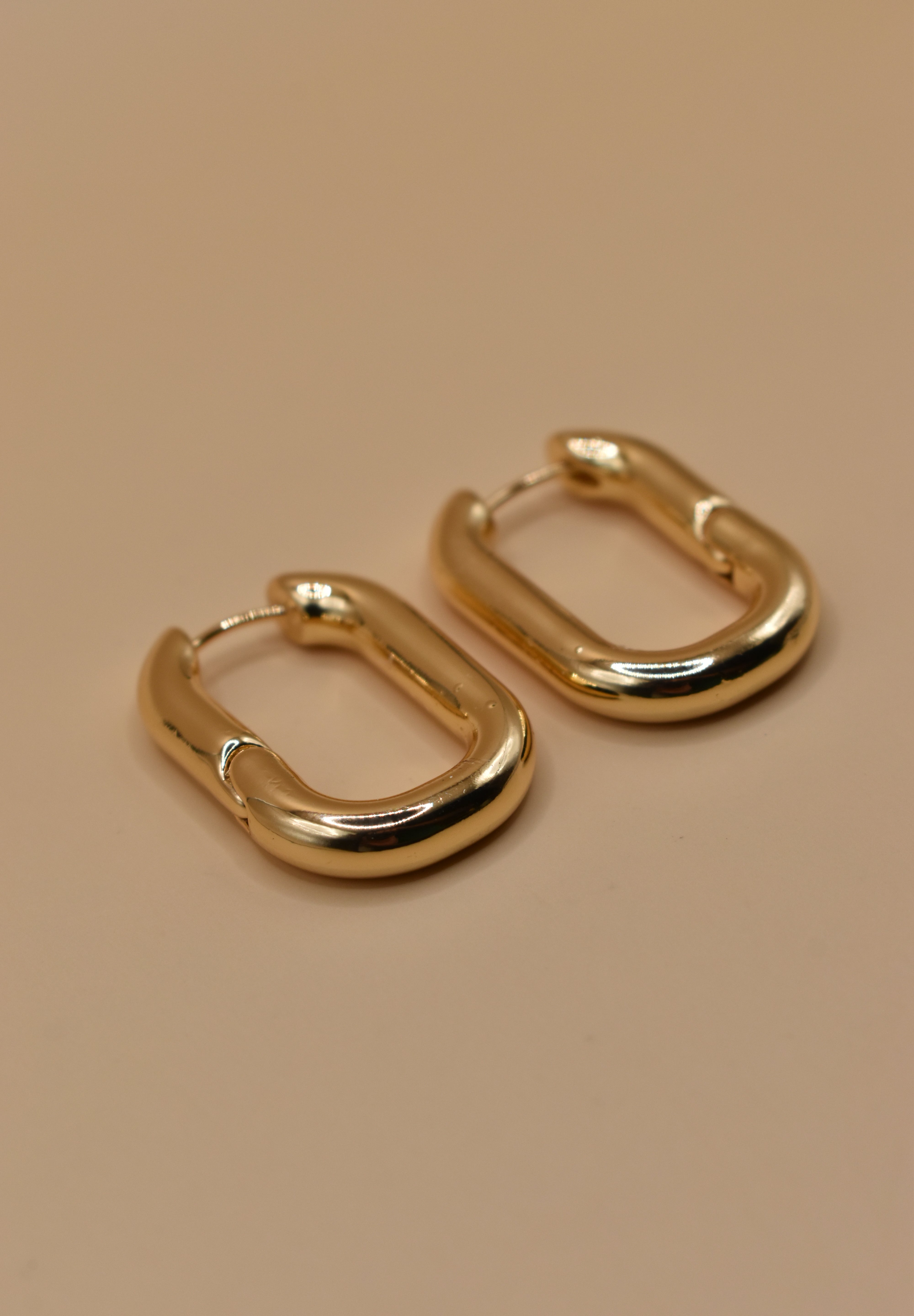 Gold U Huggies Earrings with curved hoop charm design