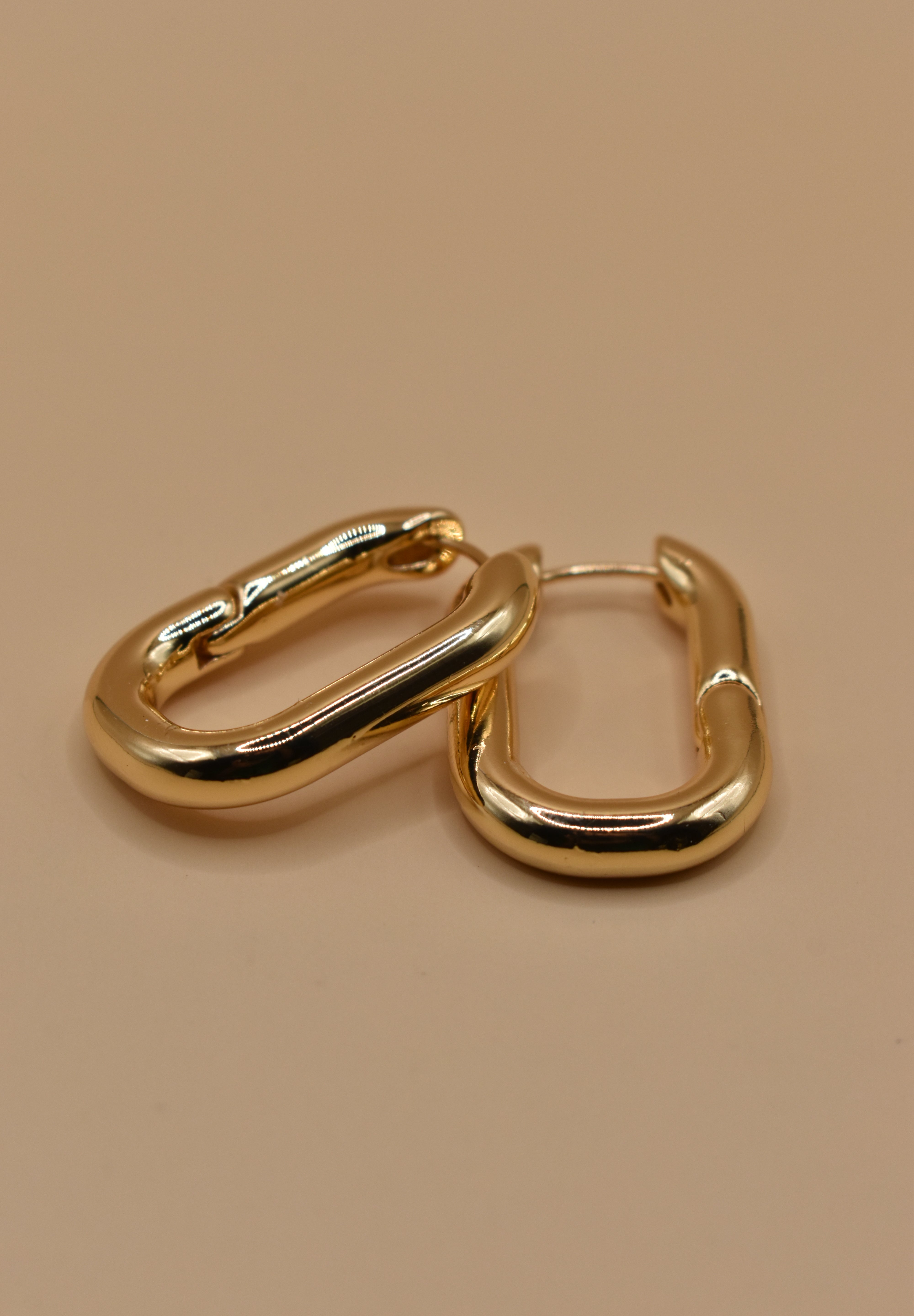 Gold U Huggies Earrings with curved hoop charm design