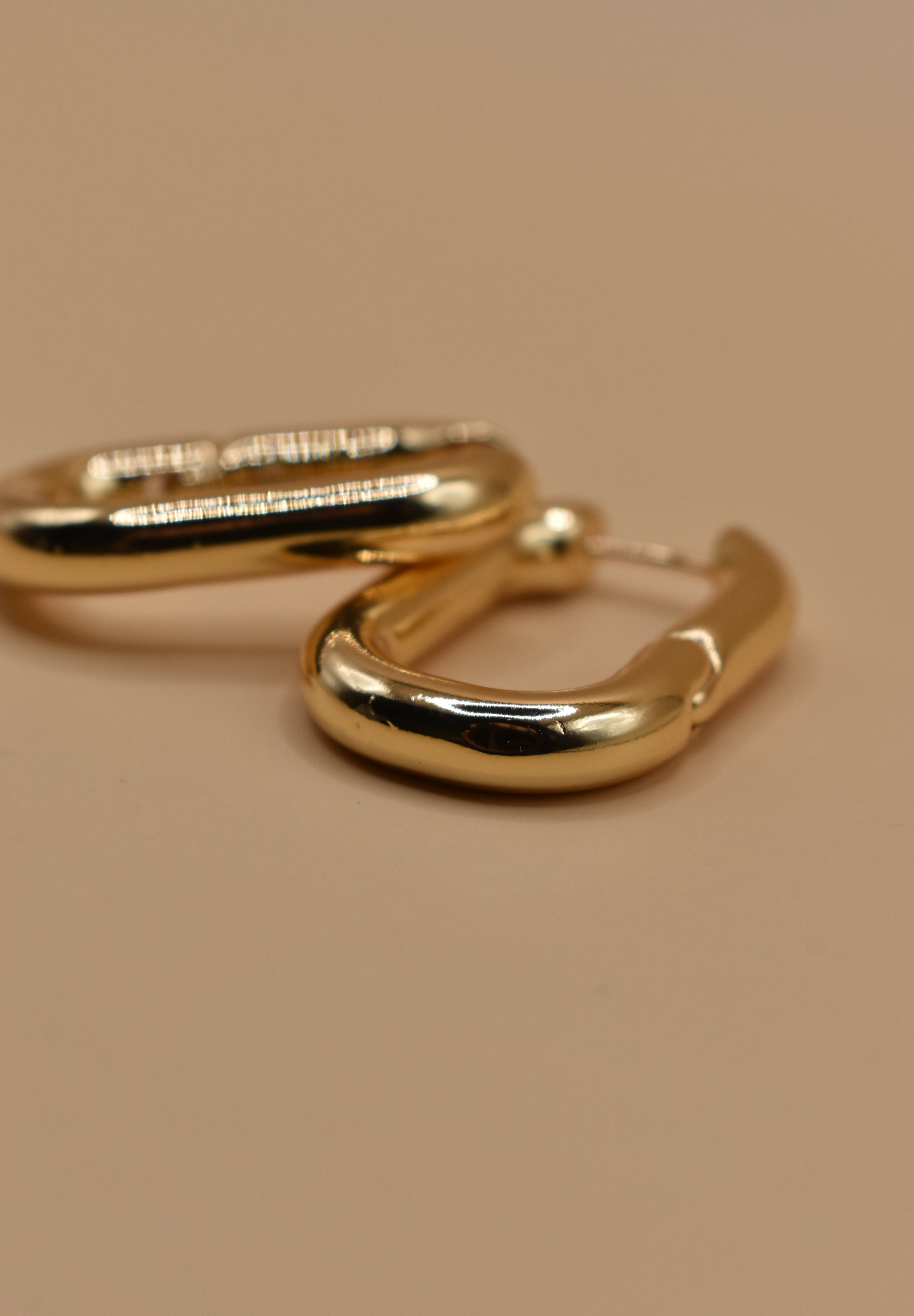 Gold U Huggies Earrings with curved hoop charm design