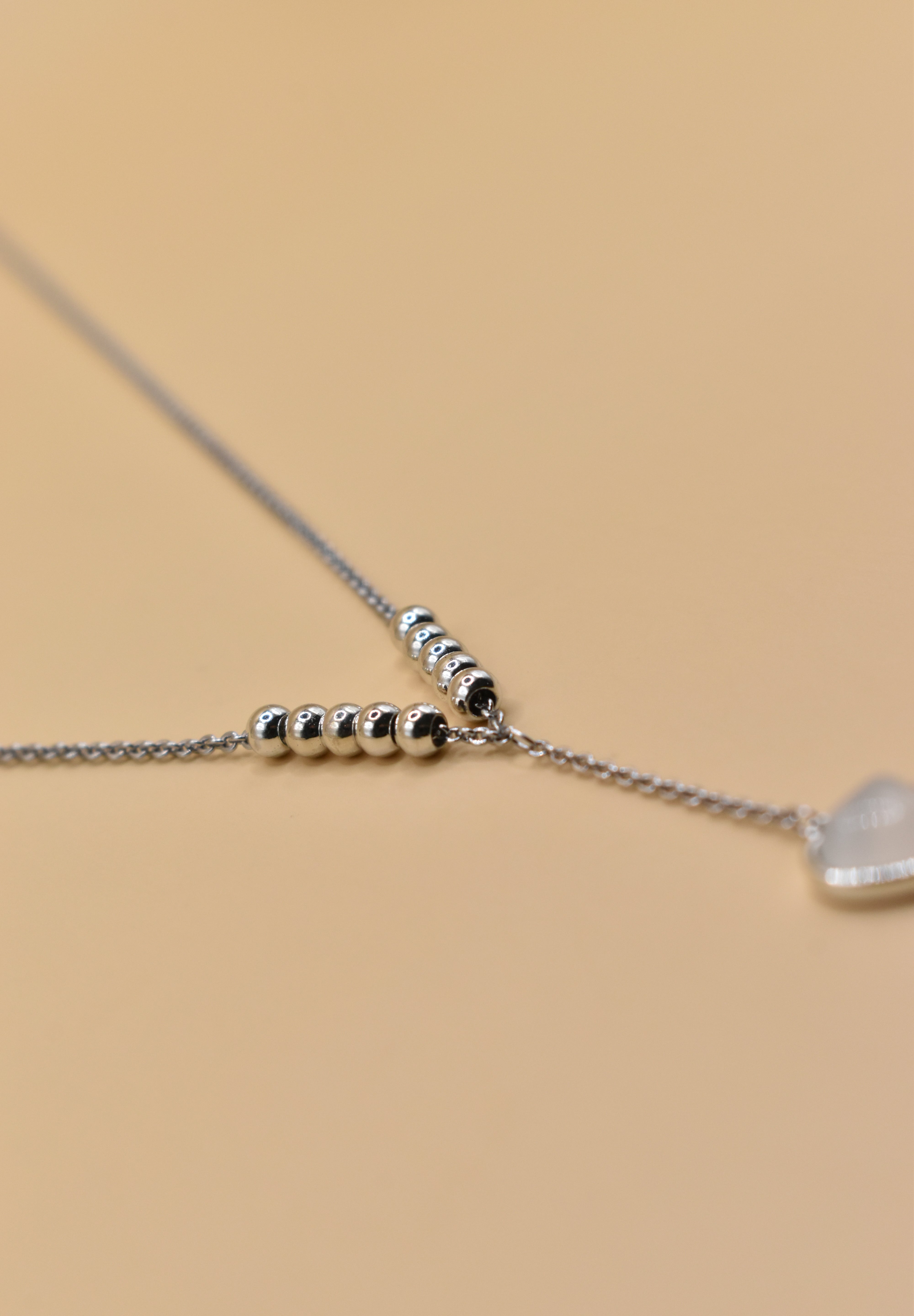 Heart necklace in rhodium stainless steel with drop pendant