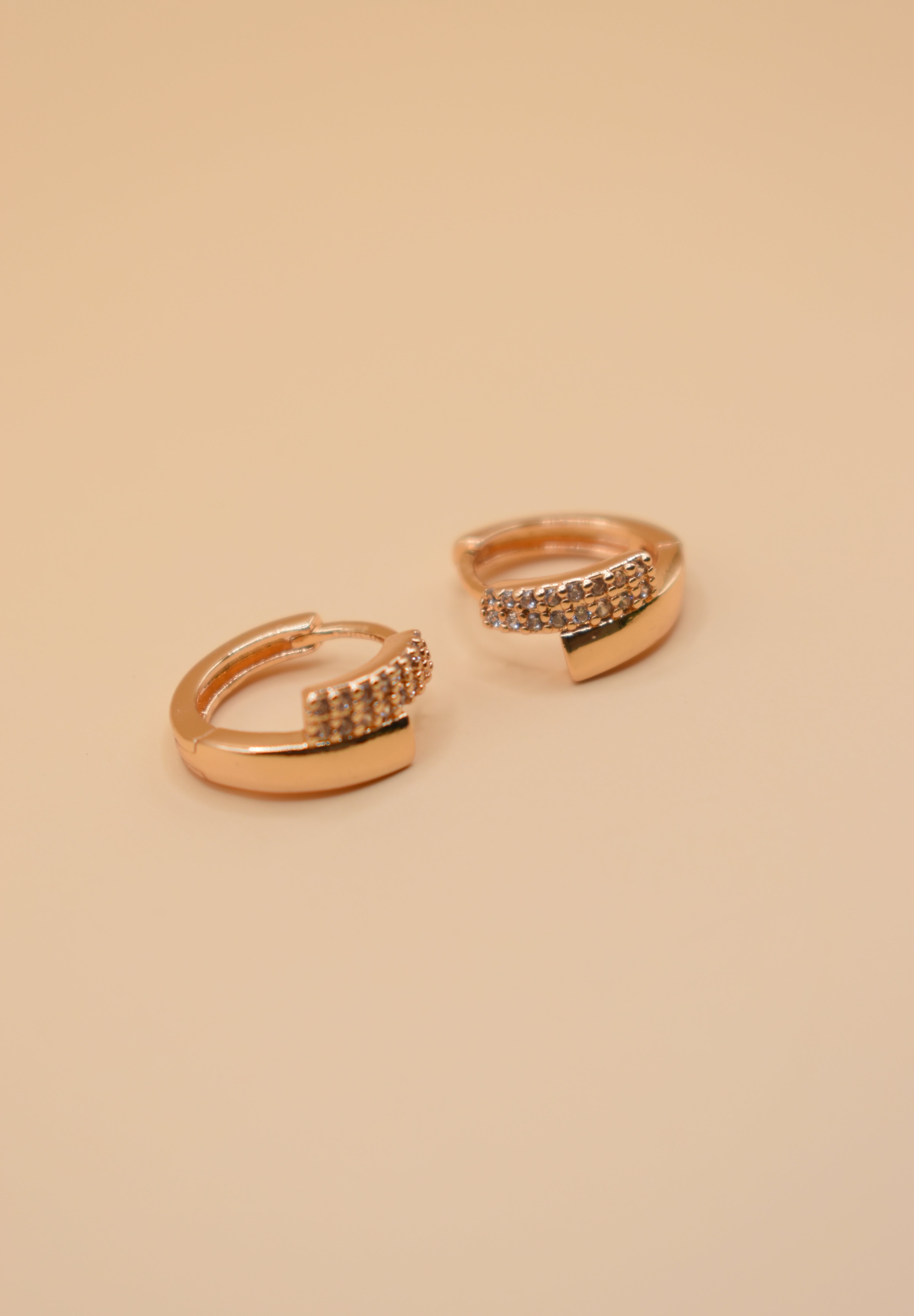 Gold loop huggies charm circle hoop earrings close-up