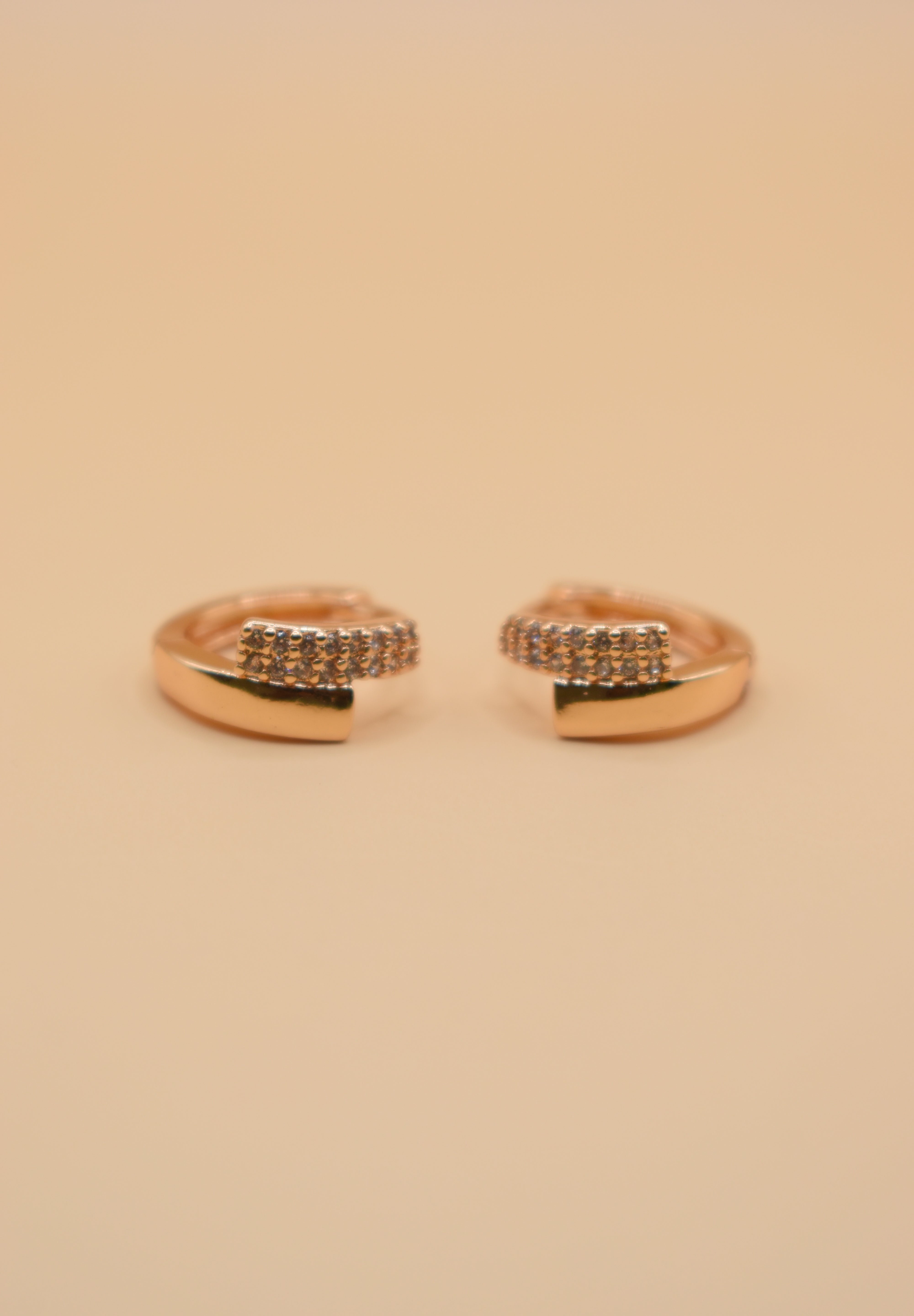 Gold loop huggies charm circle hoop earrings close-up