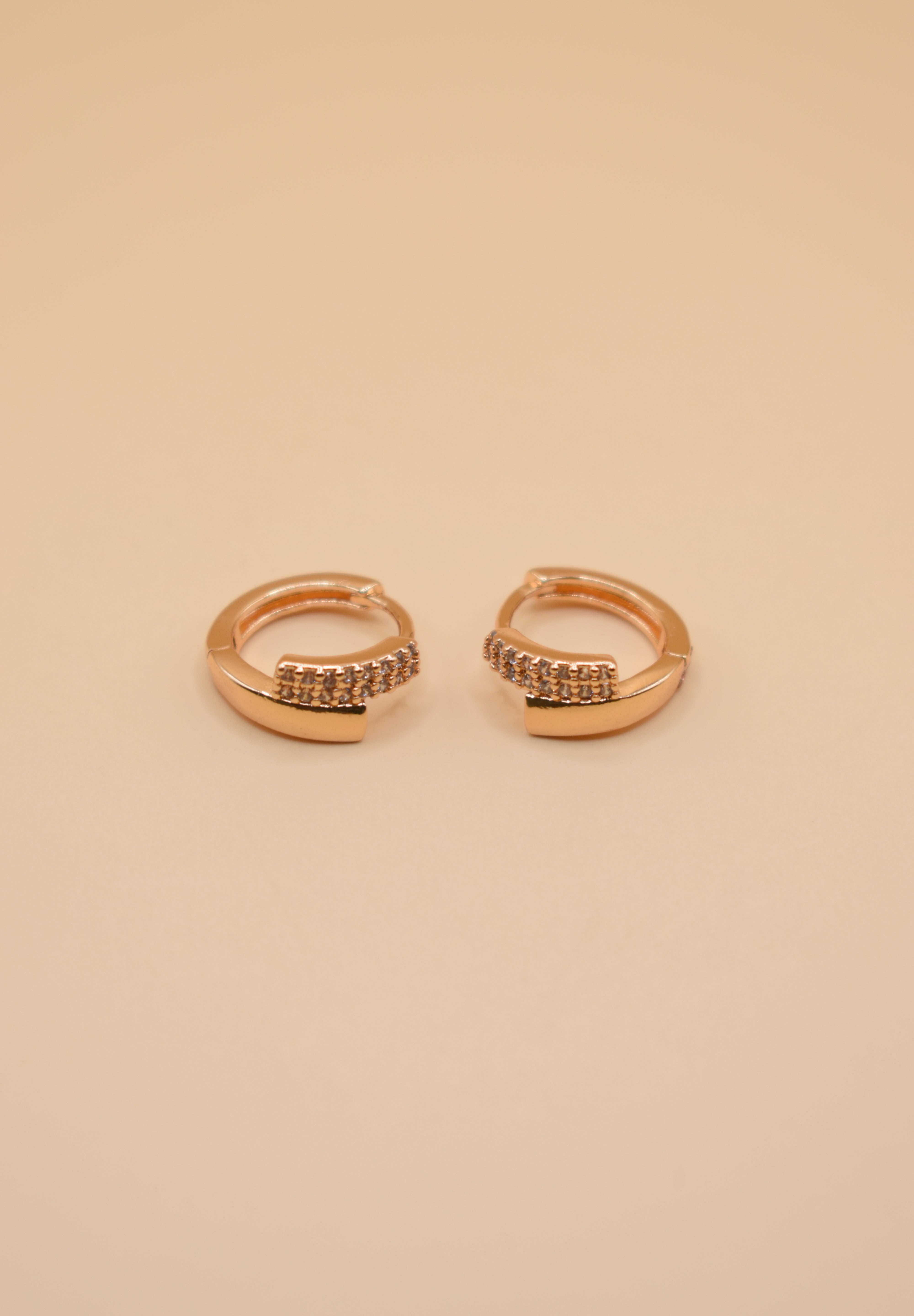 Gold loop huggies charm circle hoop earrings close-up