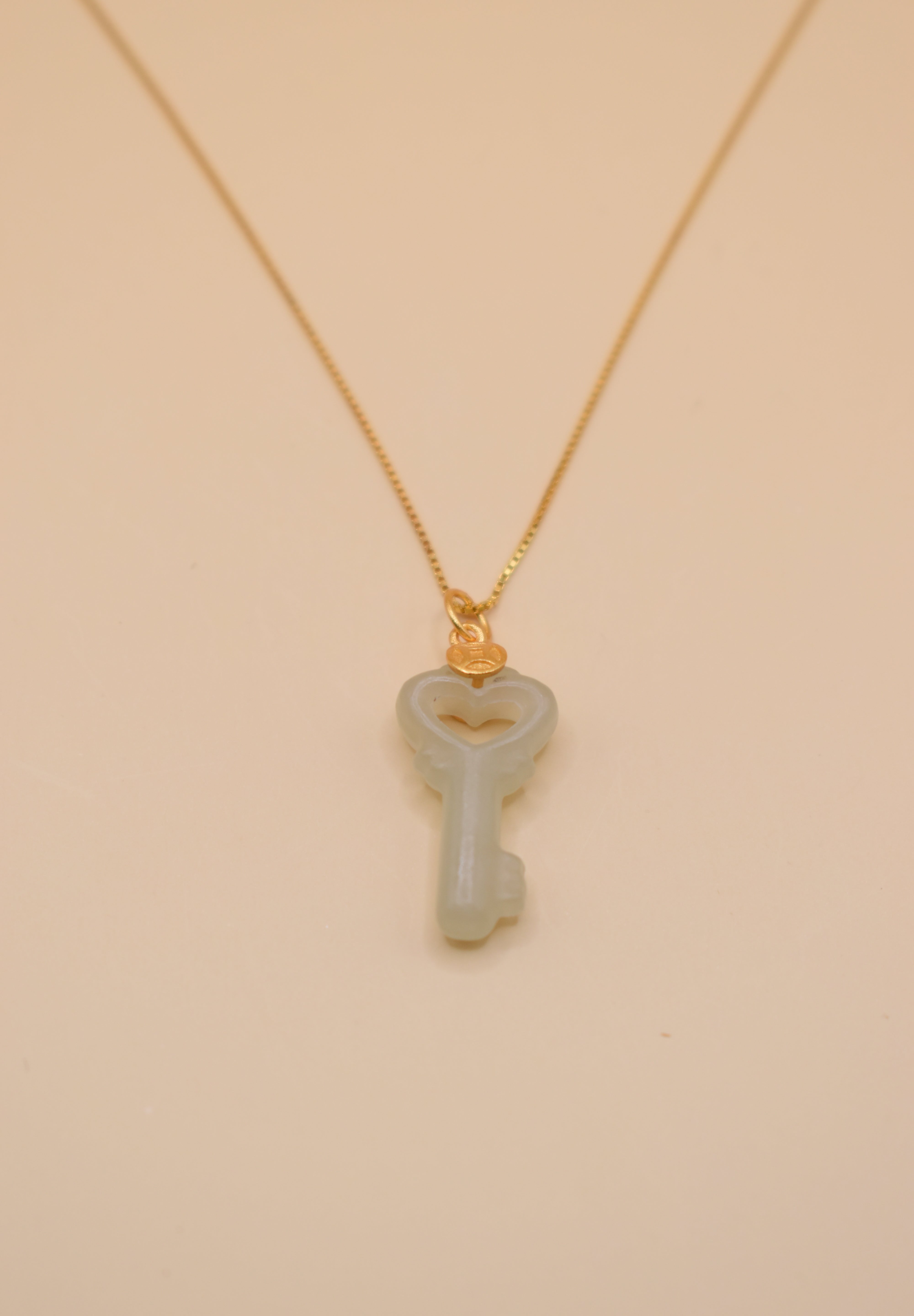 Gold key pendant necklace with jade charm on dainty chain