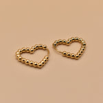 Gold heart huggies hoop earrings with charm design