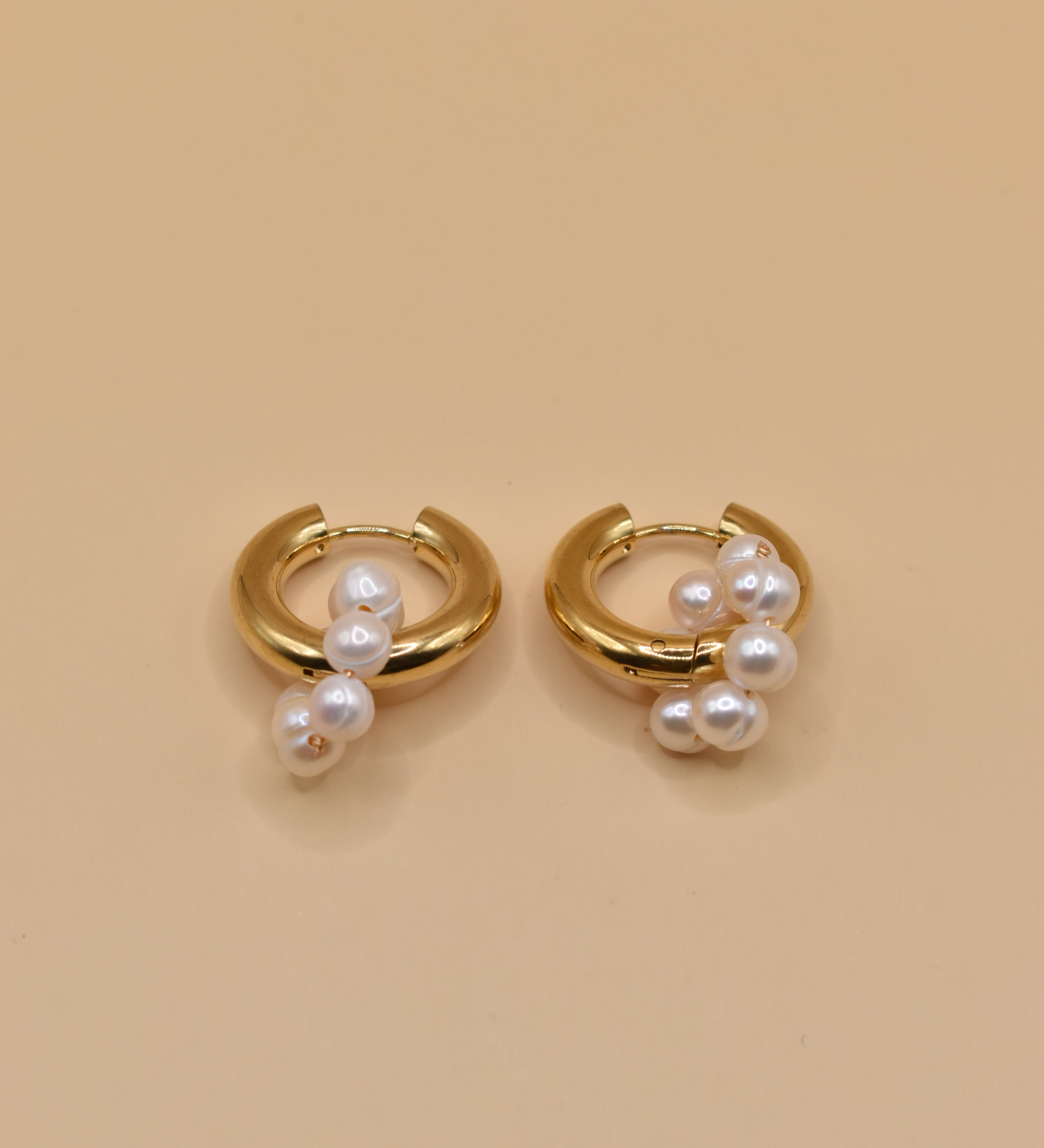 Pearl statement huggies earrings with secure closure