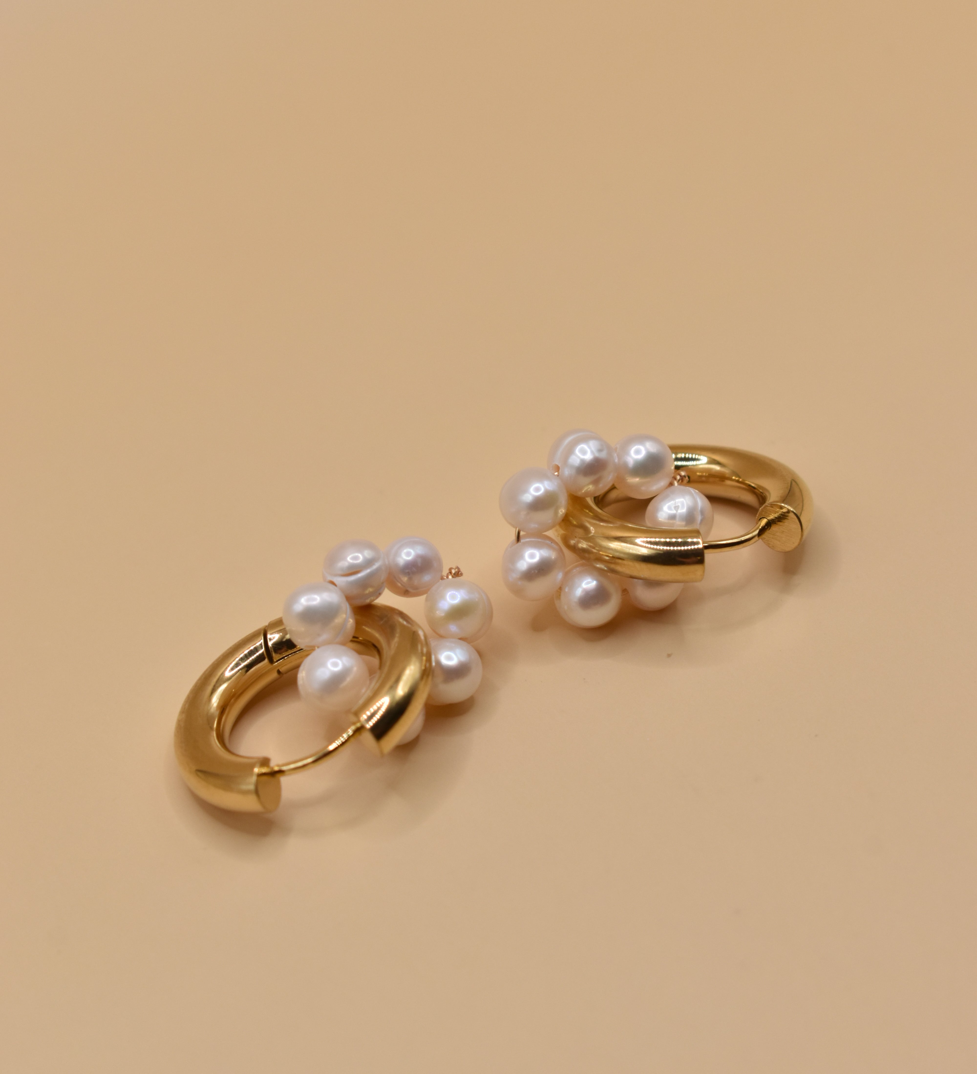 Pearl statement huggies earrings with secure closure