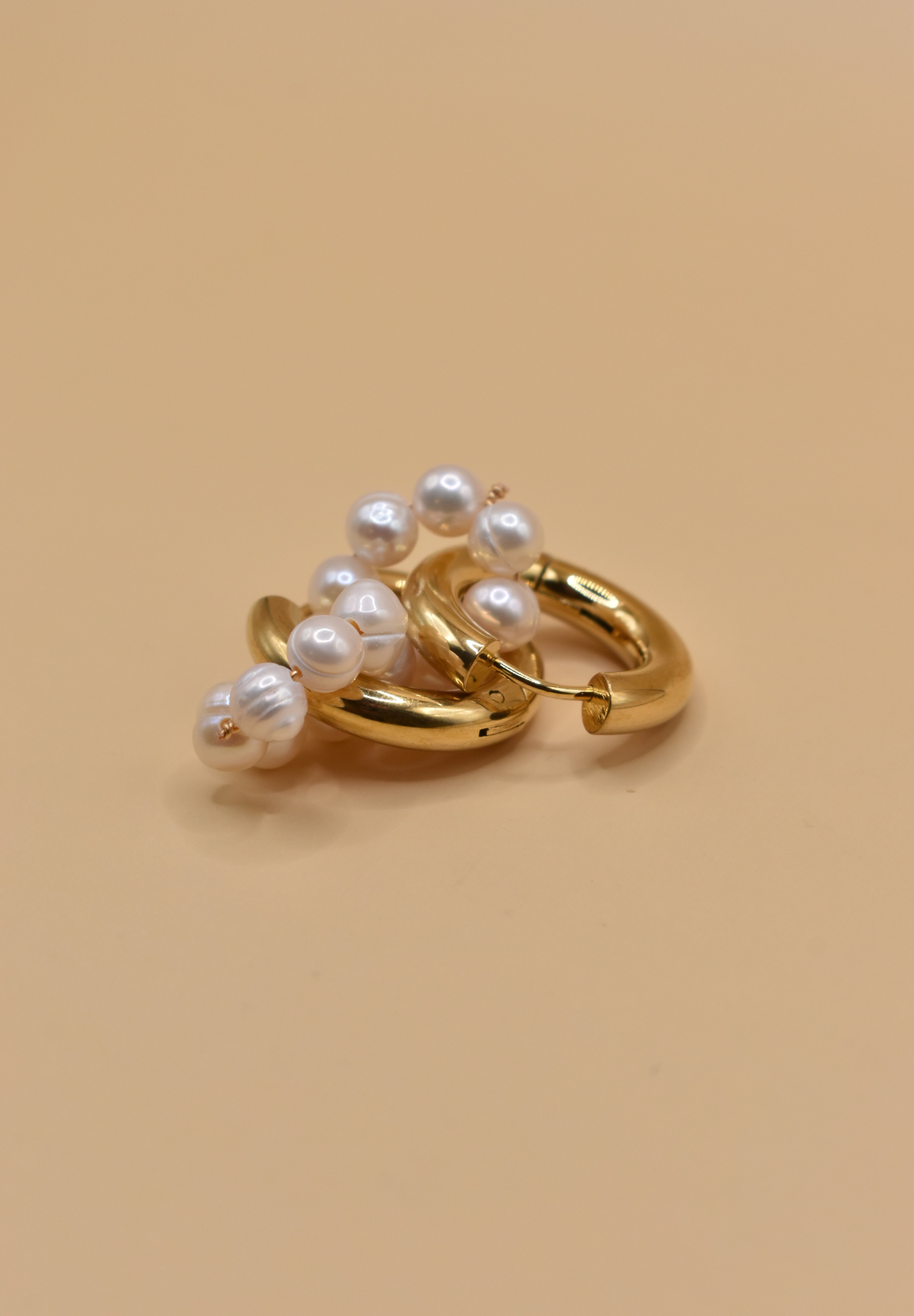 Pearl statement huggies earrings with secure closure