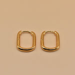 Gold U Huggies Earrings with curved hoop charm design