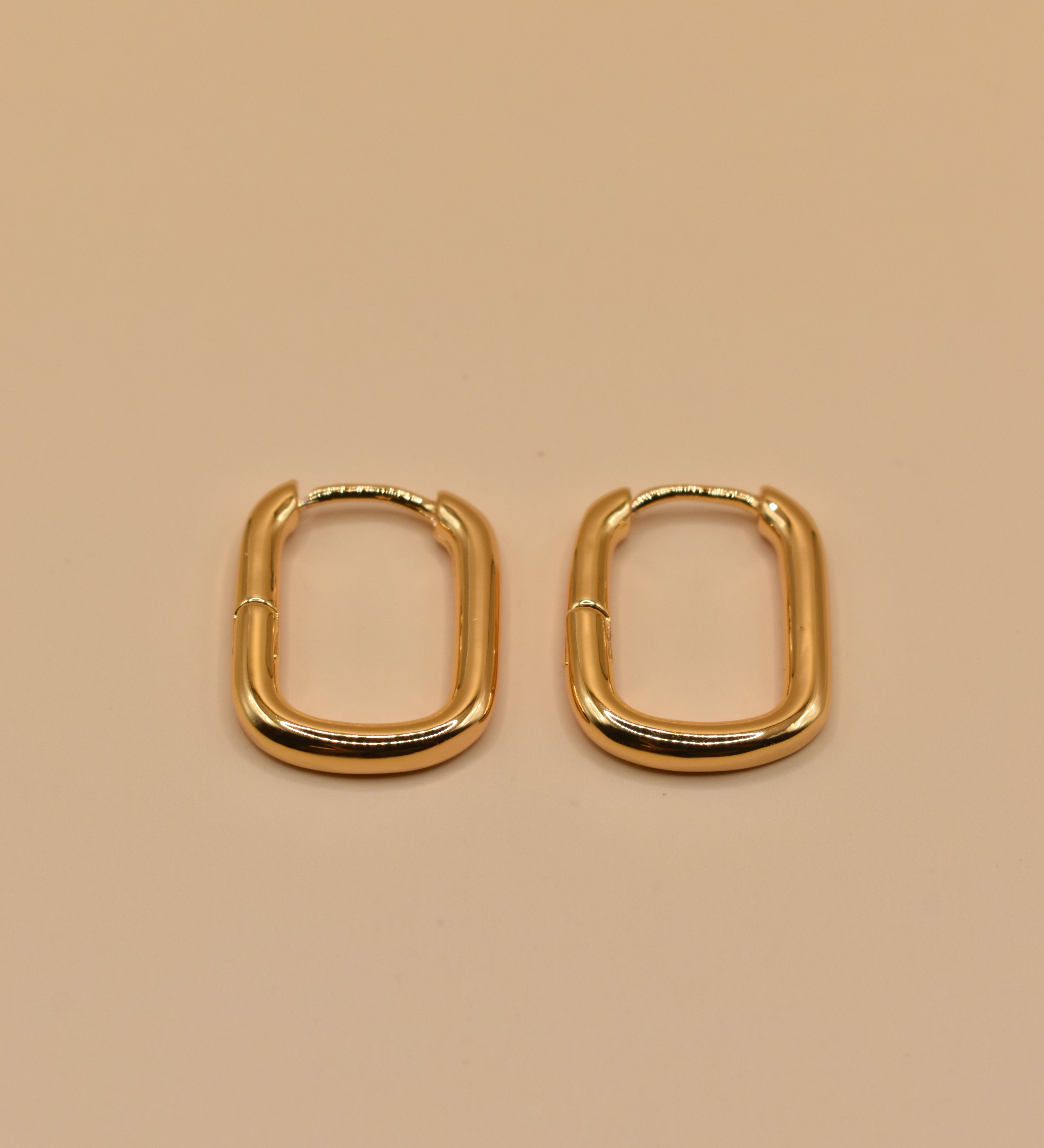 Gold U Huggies Earrings with curved hoop charm design