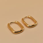 Gold U Huggies Earrings with curved hoop charm design