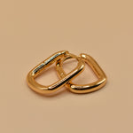 Gold U Huggies Earrings with curved hoop charm design