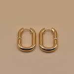 Gold U Huggies Earrings with curved hoop charm design