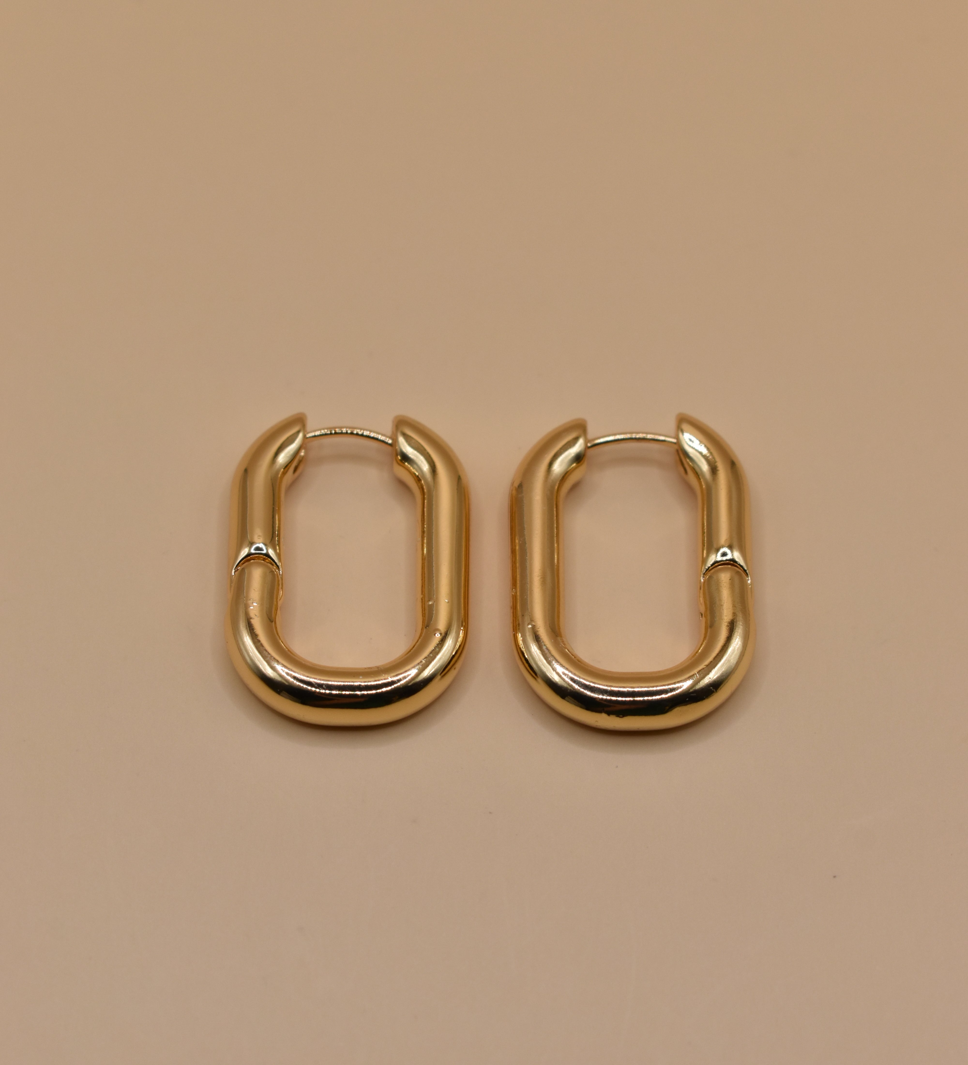 Gold U Huggies Earrings with curved hoop charm design