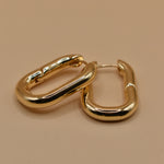 Gold U Huggies Earrings with curved hoop charm design