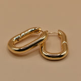 Gold U Huggies Earrings with curved hoop charm design