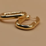 Gold U Huggies Earrings with curved hoop charm design