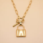 Gold lock pendant necklace on paperclip chain