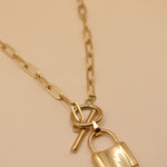 Gold lock pendant necklace on paperclip chain