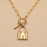 Gold lock pendant necklace on paperclip chain