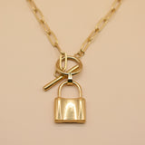 Gold lock pendant necklace on paperclip chain