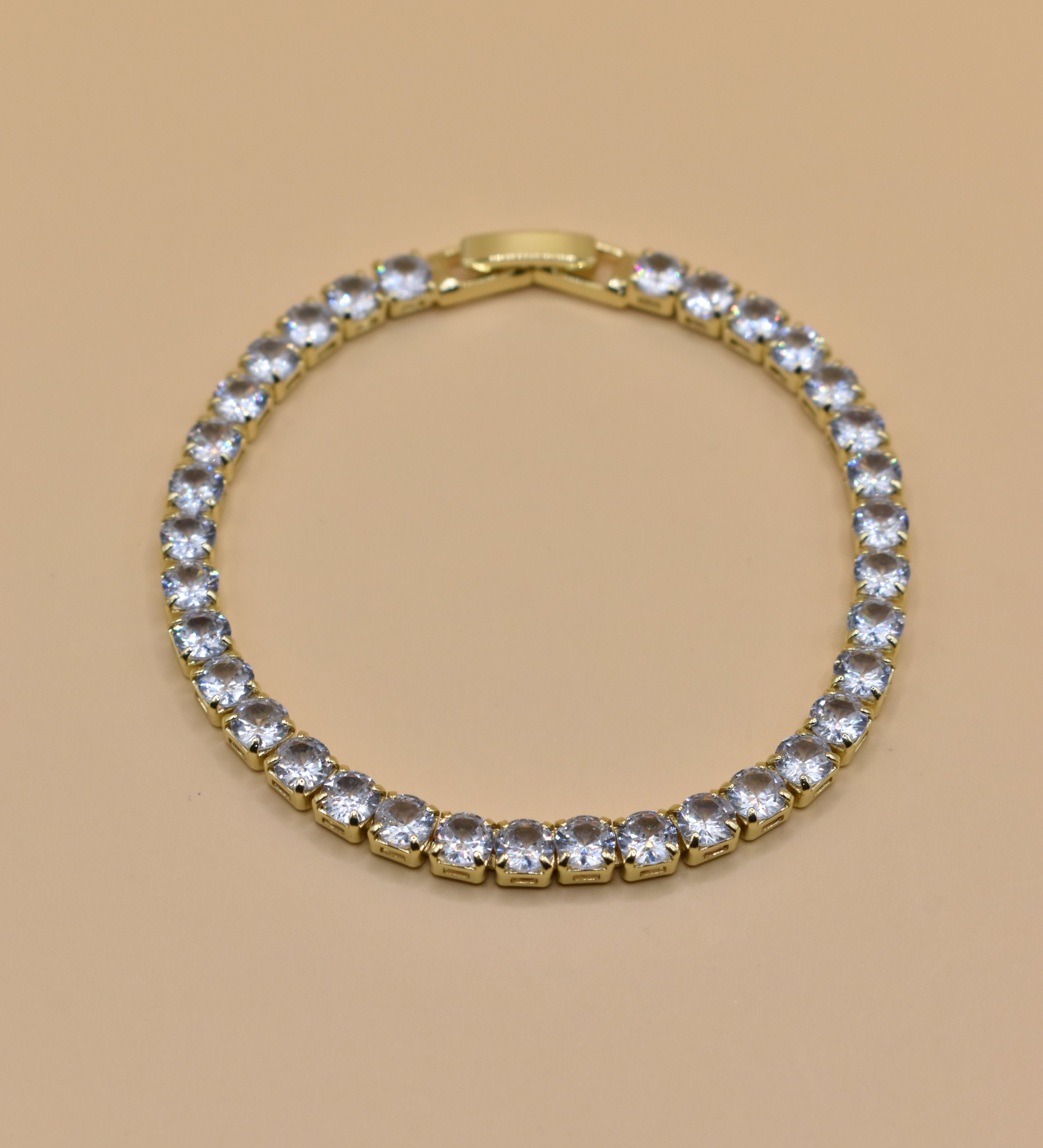 Gold tennis bracelet with green emerald zircon stones
