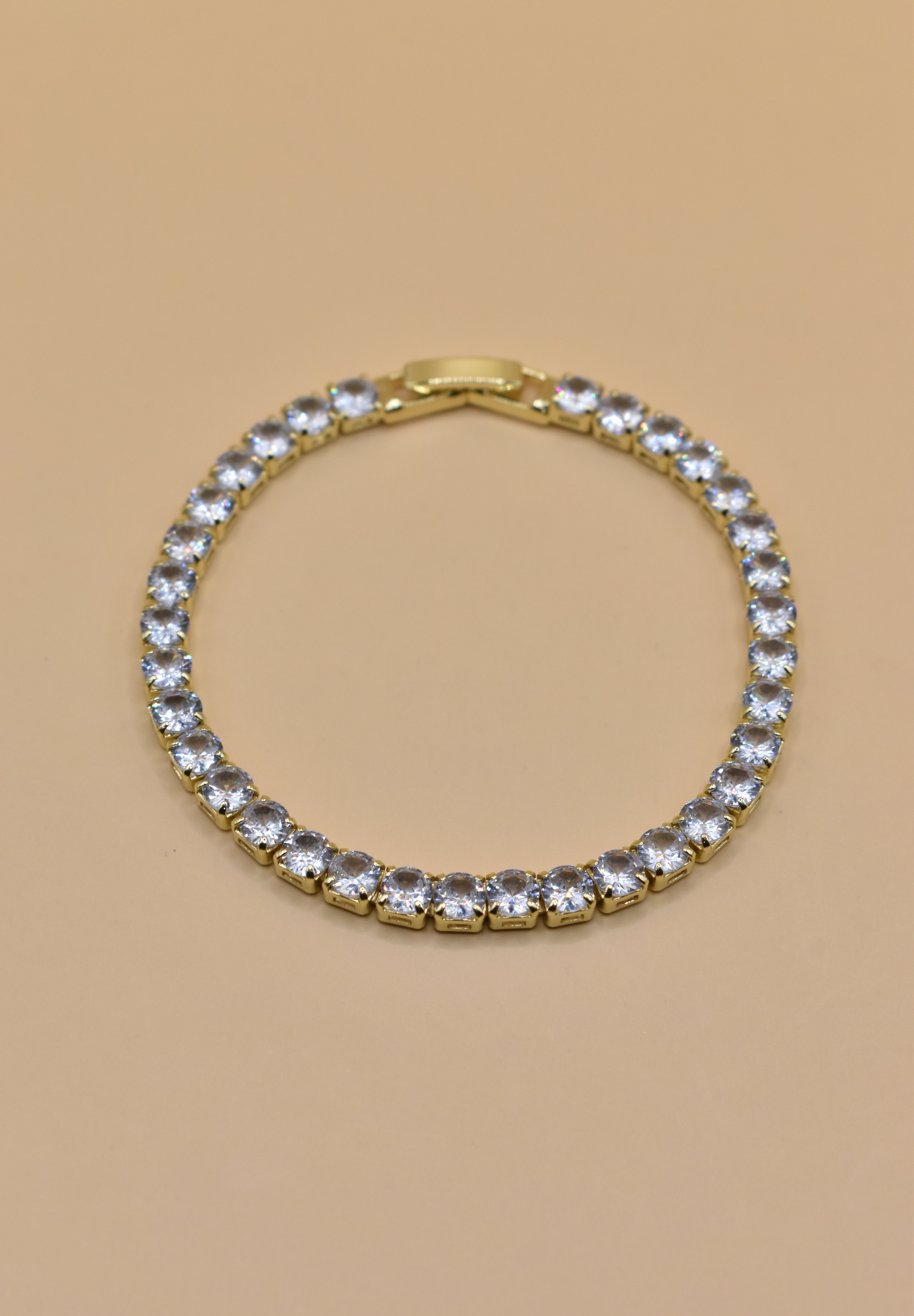 Gold tennis bracelet with green emerald zircon stones