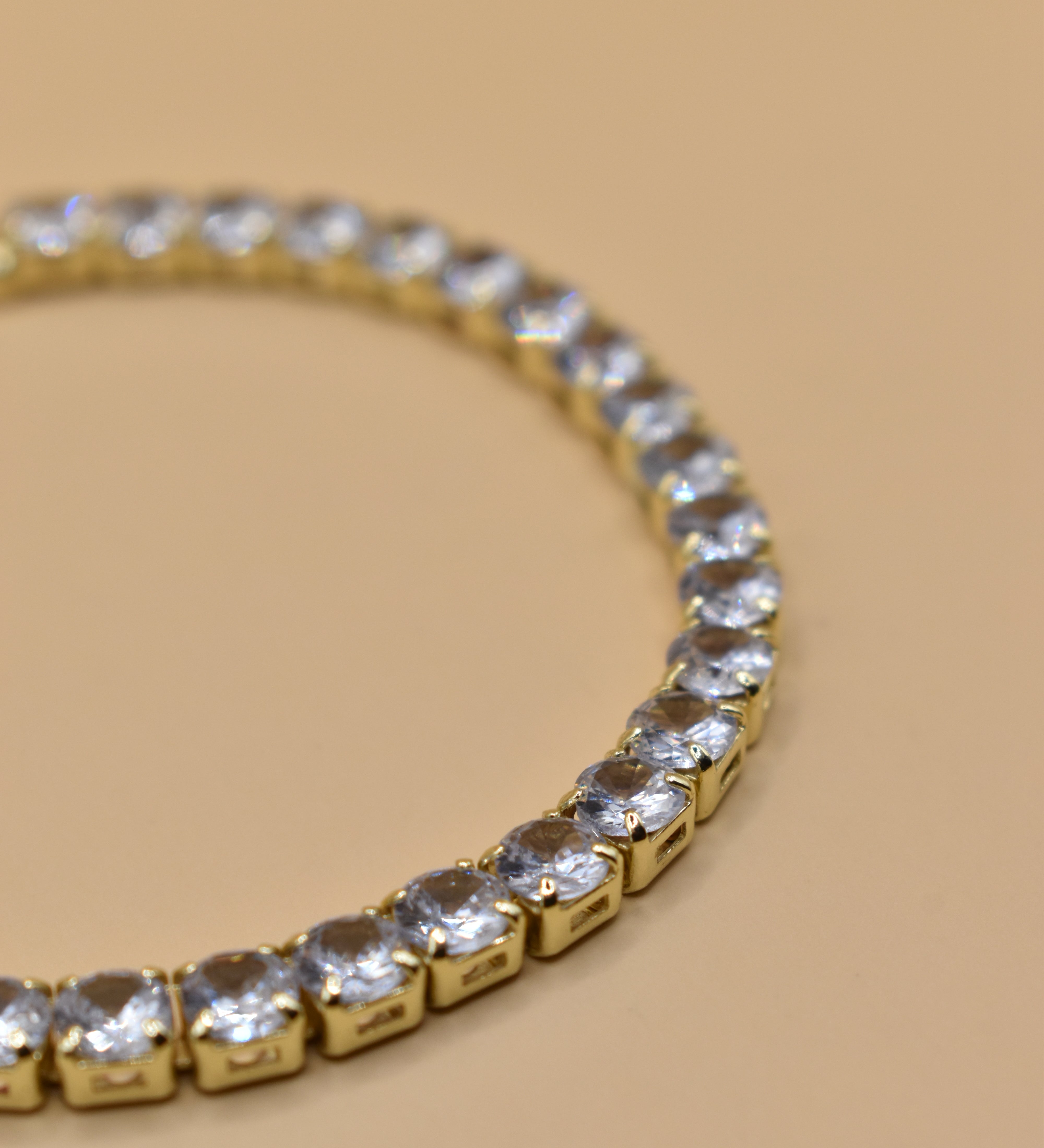 Gold tennis bracelet with green emerald zircon stones