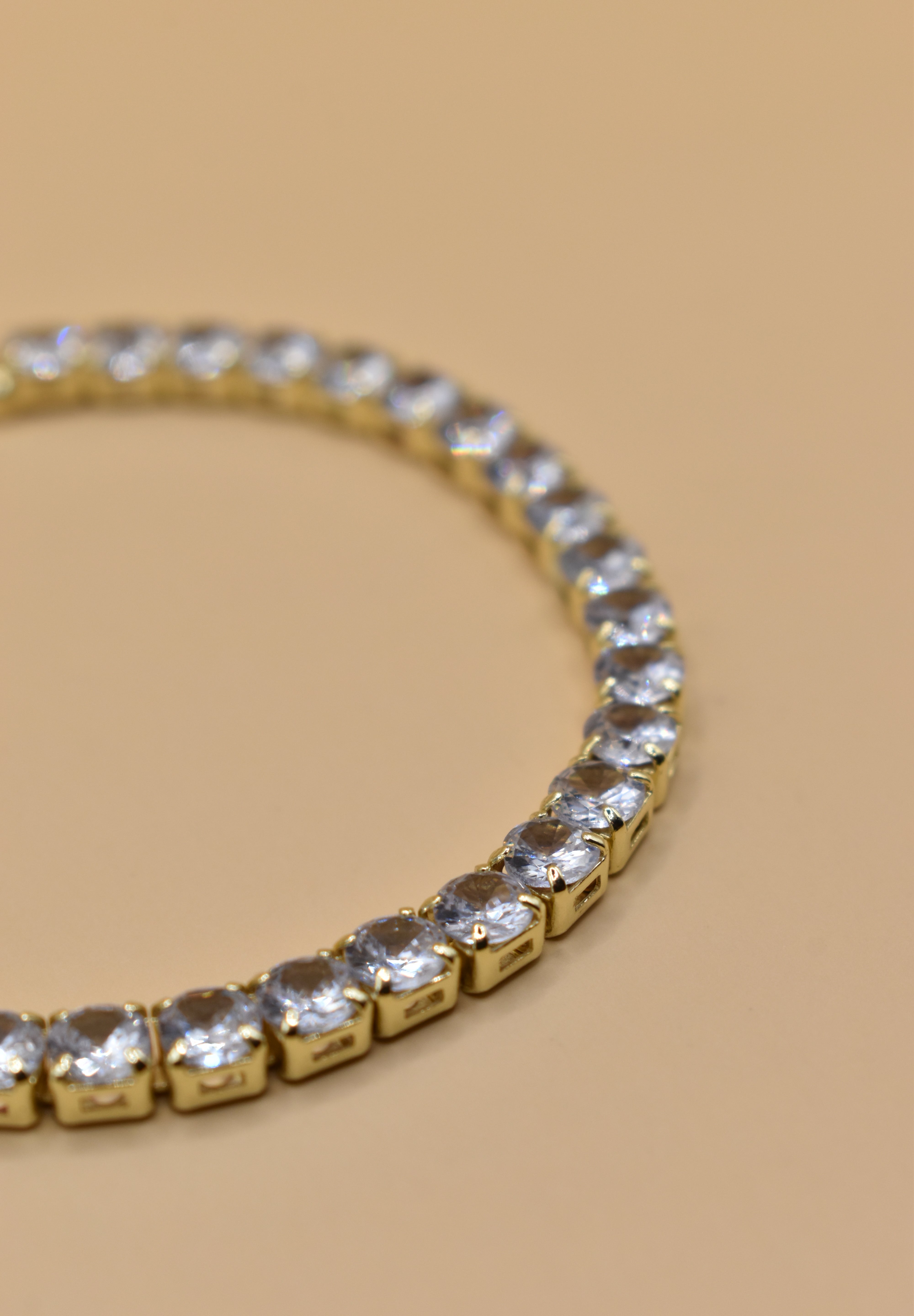 Gold tennis bracelet with green emerald zircon stones