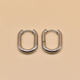 18K gold oval huggie hoop earrings with polished finish