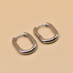 18K gold oval huggie hoop earrings with polished finish