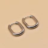18K gold oval huggie hoop earrings with polished finish