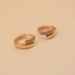 Gold loop huggies charm circle hoop earrings close-up