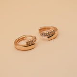 Gold loop huggies charm circle hoop earrings close-up