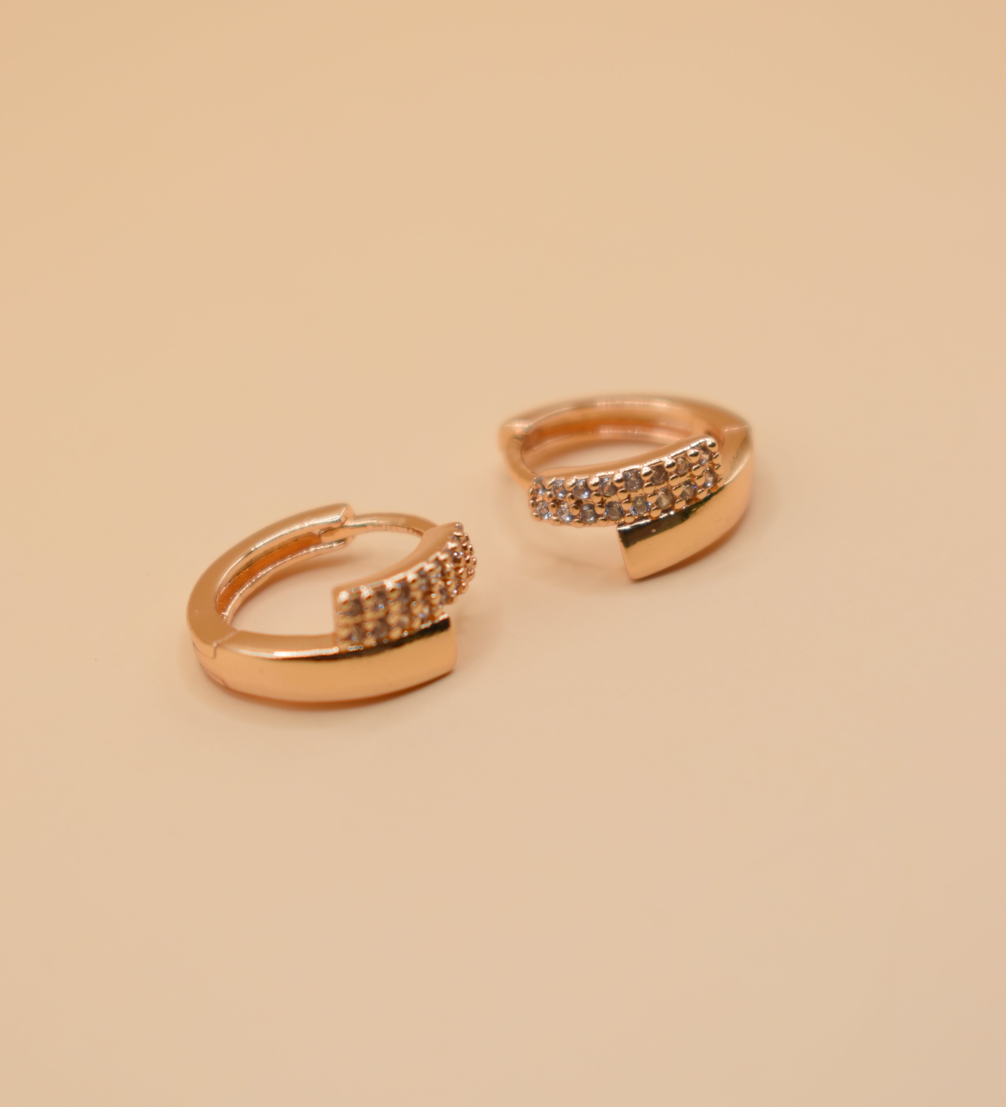 Gold loop huggies charm circle hoop earrings close-up