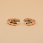 Gold loop huggies charm circle hoop earrings close-up