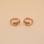 Gold loop huggies charm circle hoop earrings close-up