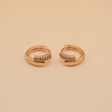 Gold loop huggies charm circle hoop earrings close-up