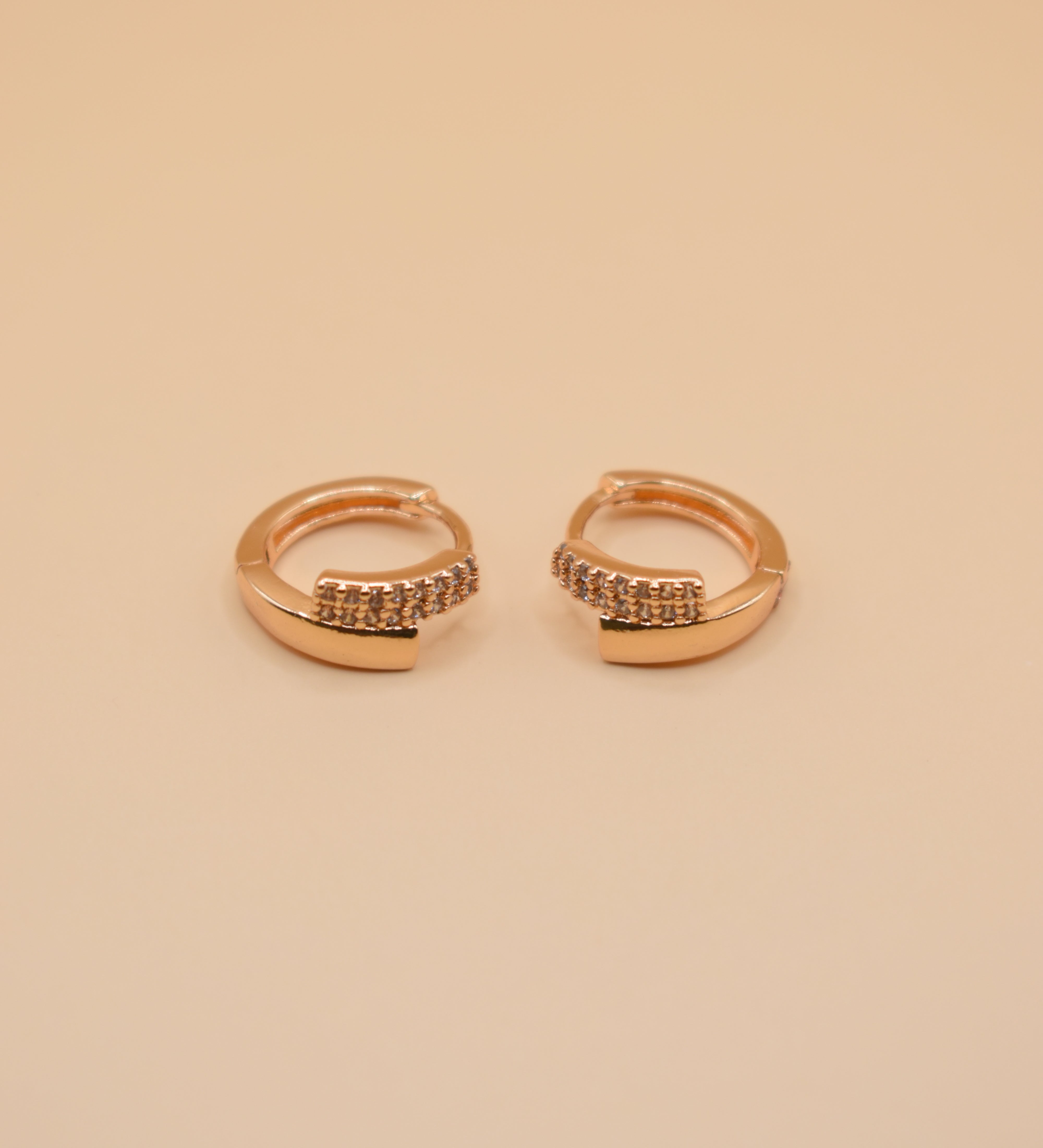 Gold loop huggies charm circle hoop earrings close-up