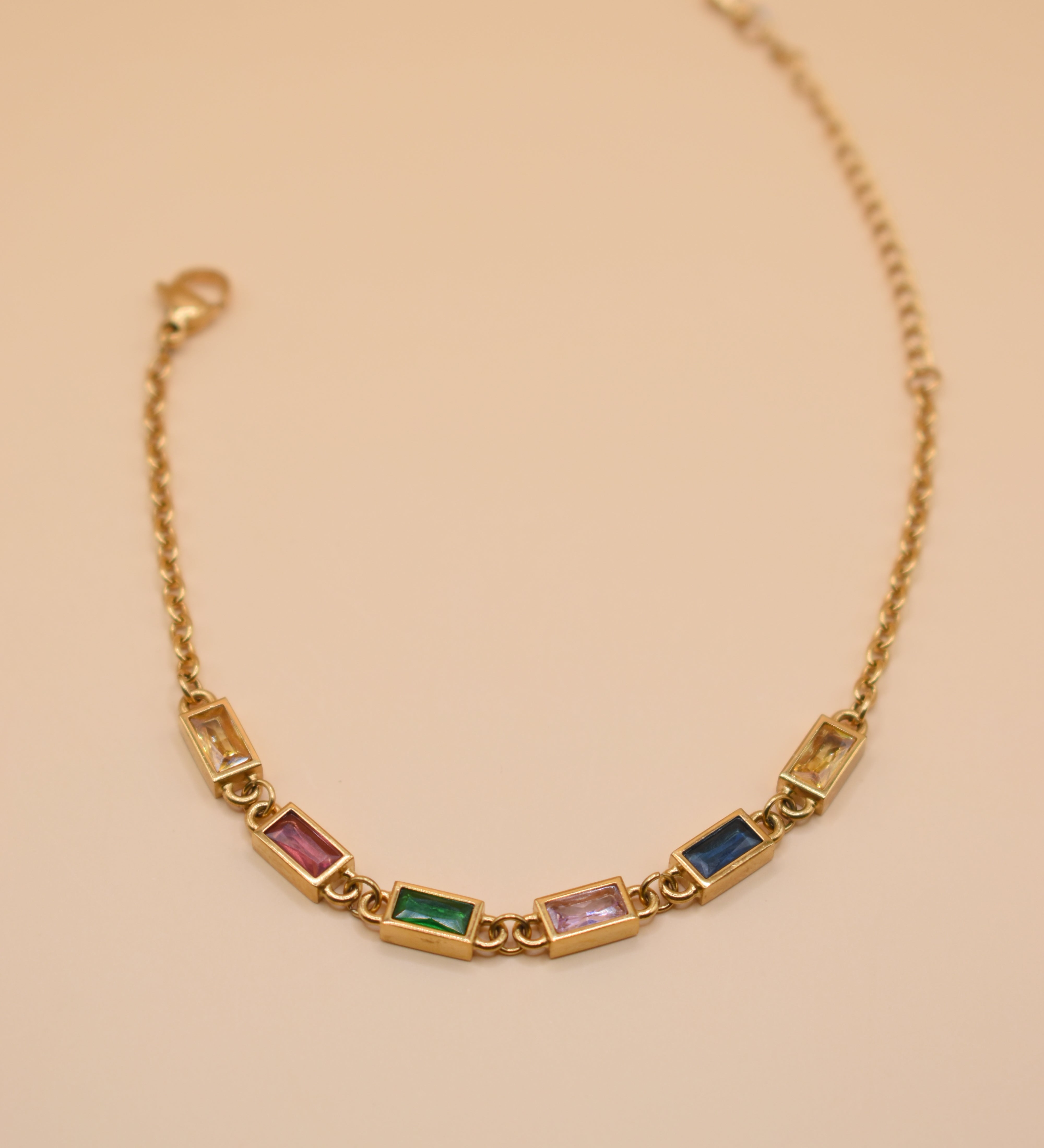 Stainless steel multicolor gold chain bracelet on white background