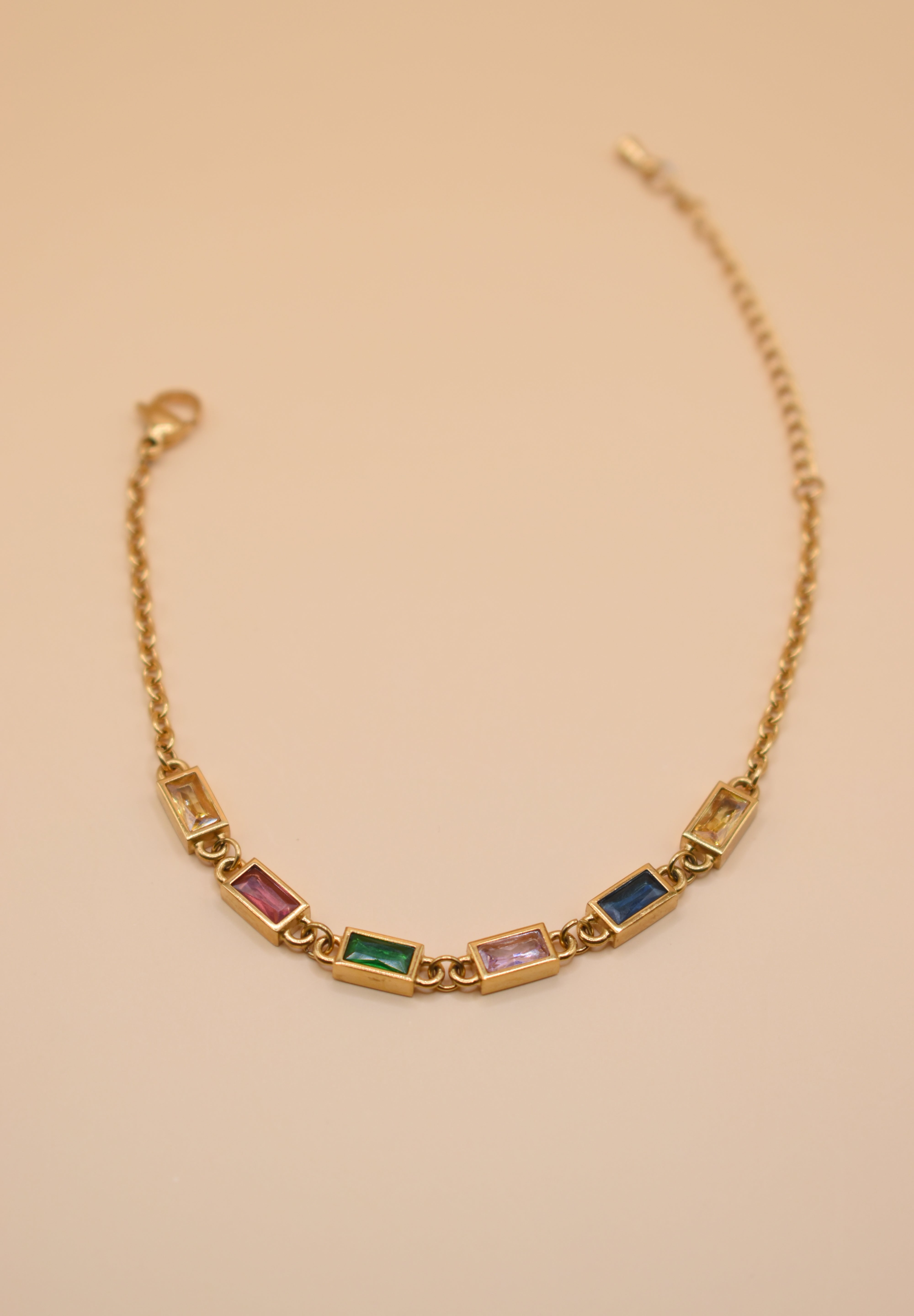 Stainless steel multicolor gold chain bracelet on white background