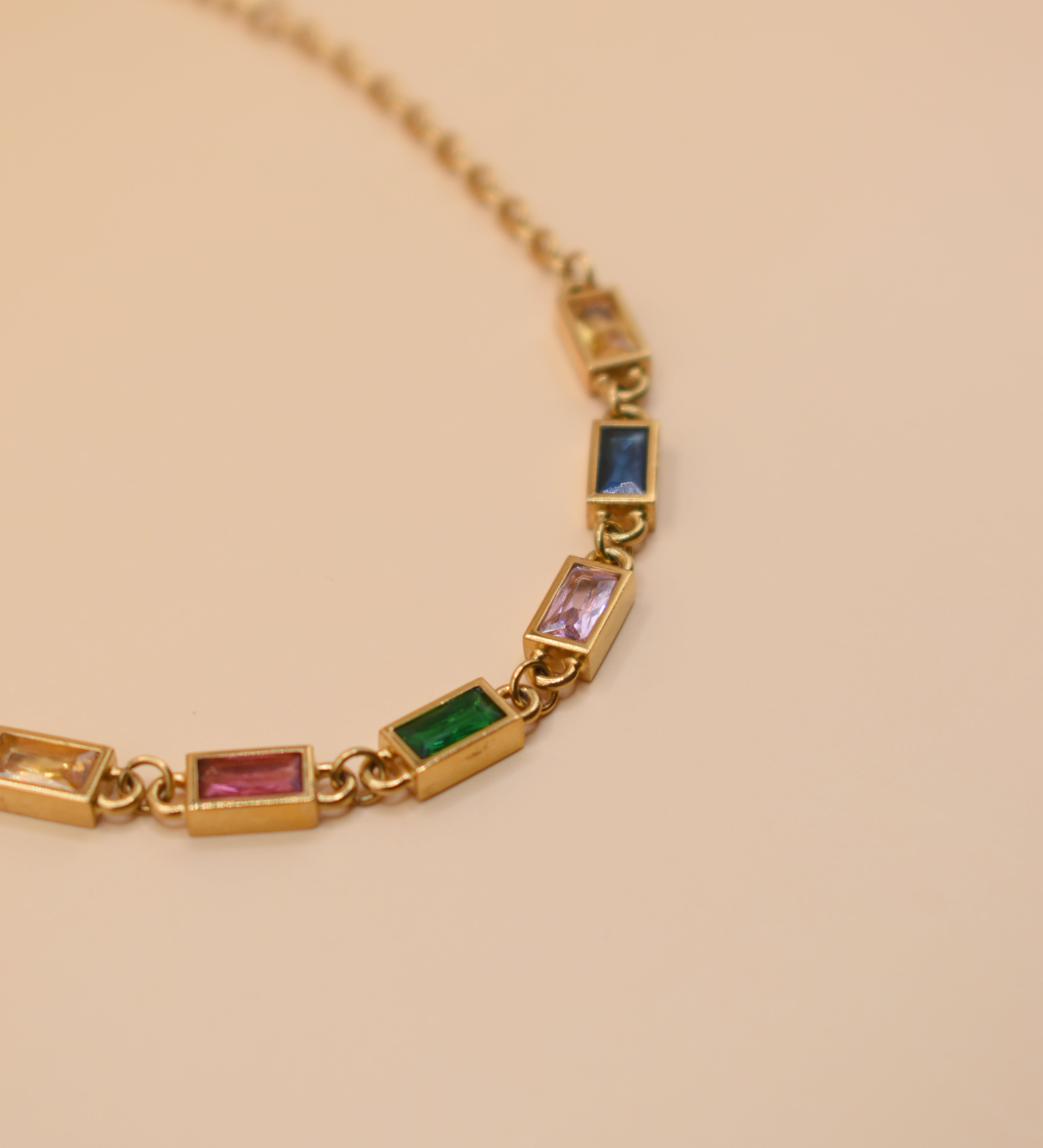 Stainless steel multicolor gold chain bracelet on white background