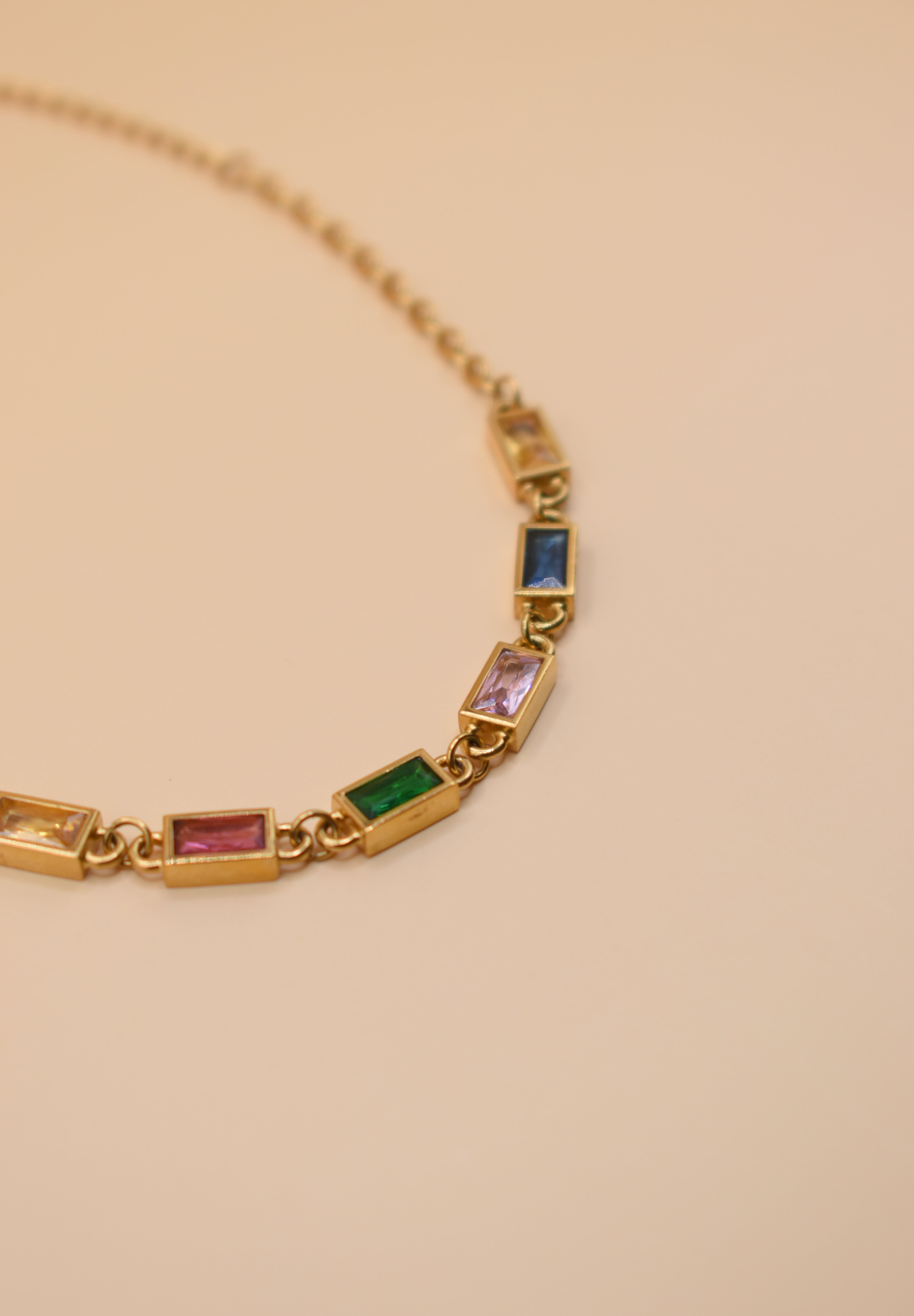 Stainless steel multicolor gold chain bracelet on white background